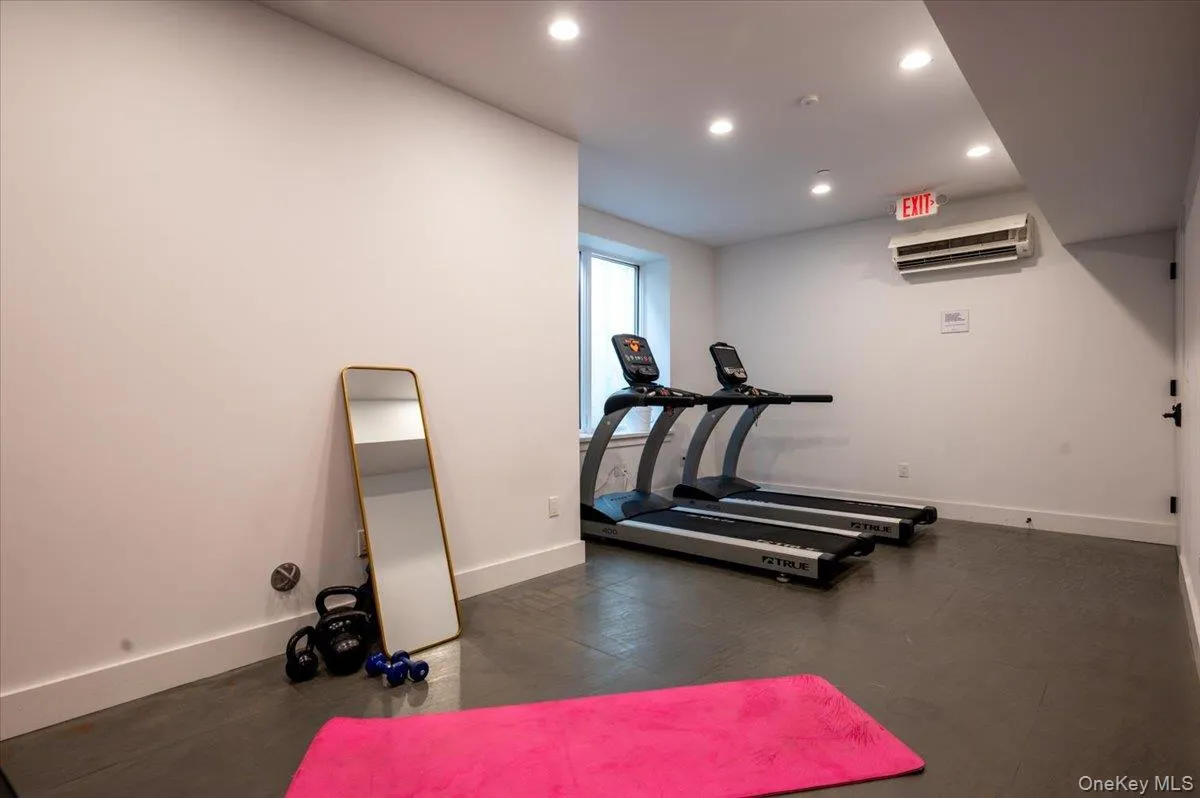 Workout room featuring recessed lighting and a wall unit AC Workout room featuring recessed lighting and a wall unit AC