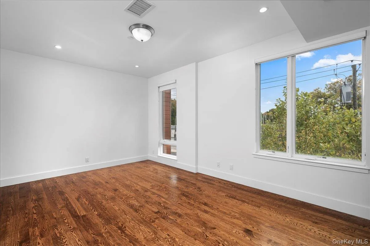 Master bedroom with recessed lighting and dark wood-style flooring Master bedroom with recessed lighting and dark wood-style flooring