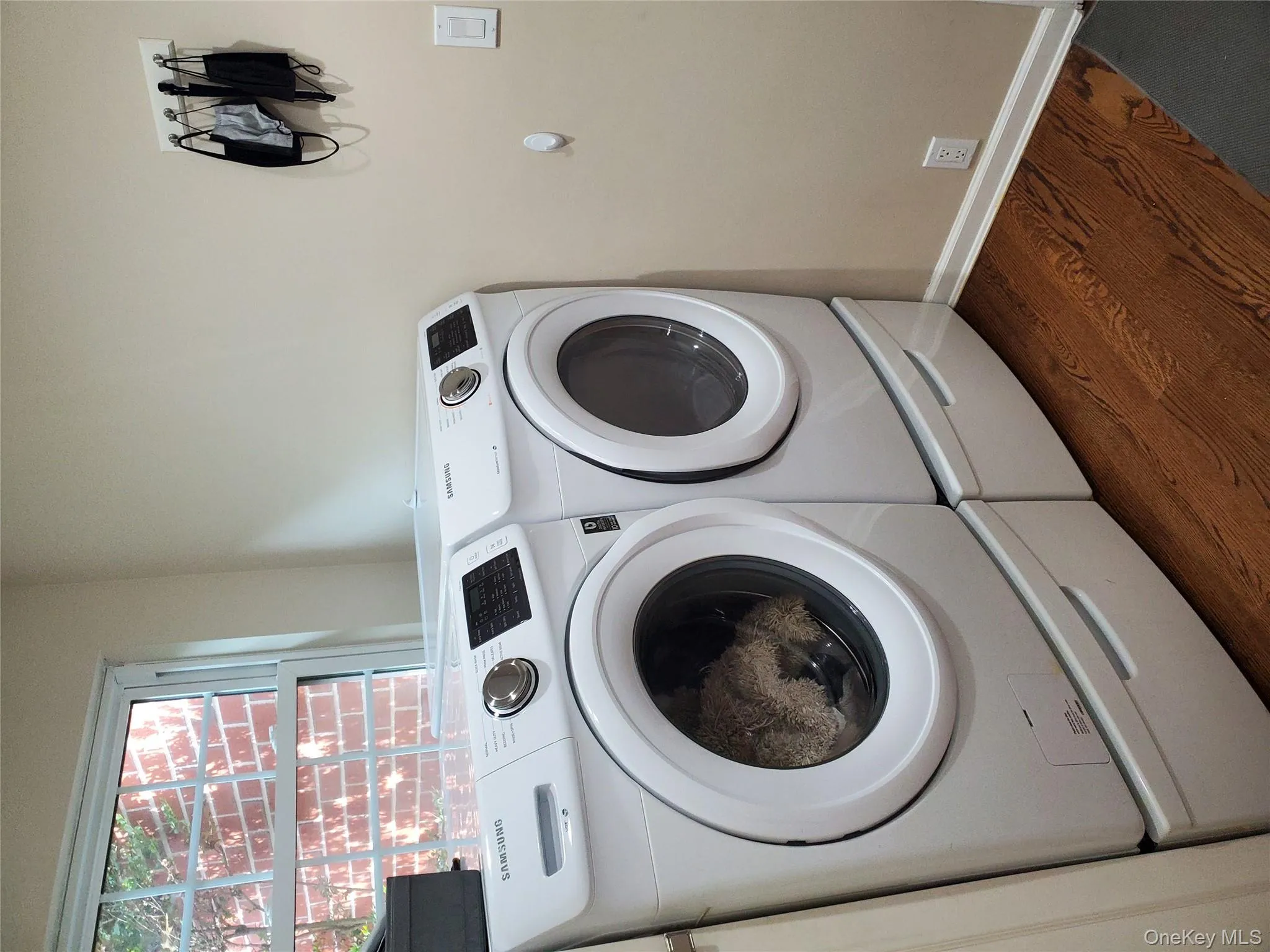 Laundry room featuring dark wood-style floors and washer and dryer Laundry room featuring dark wood-style floors and washer and dryer