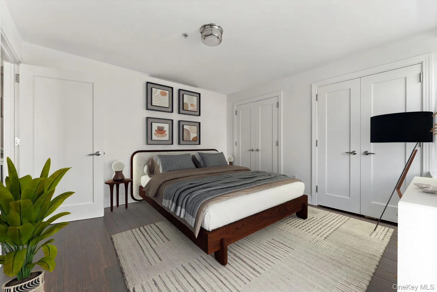 Bedroom with multiple closets and dark wood finished floors Bedroom with multiple closets and dark wood finished floors