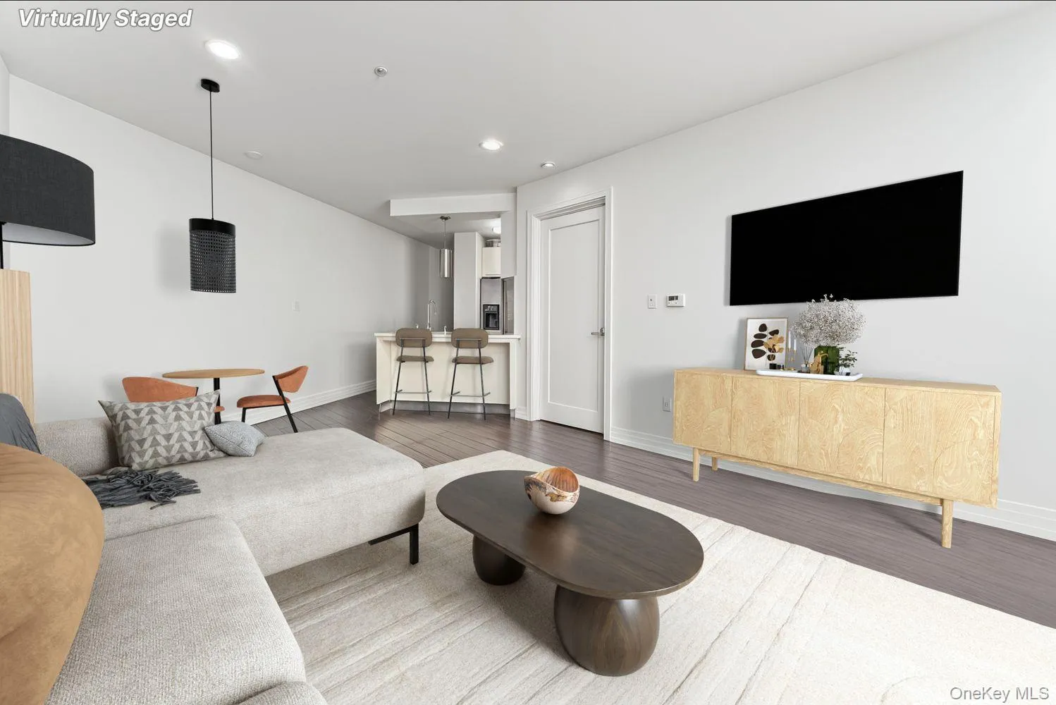 Living room featuring wood finished floors and recessed lighting Living room featuring wood finished floors and recessed lighting