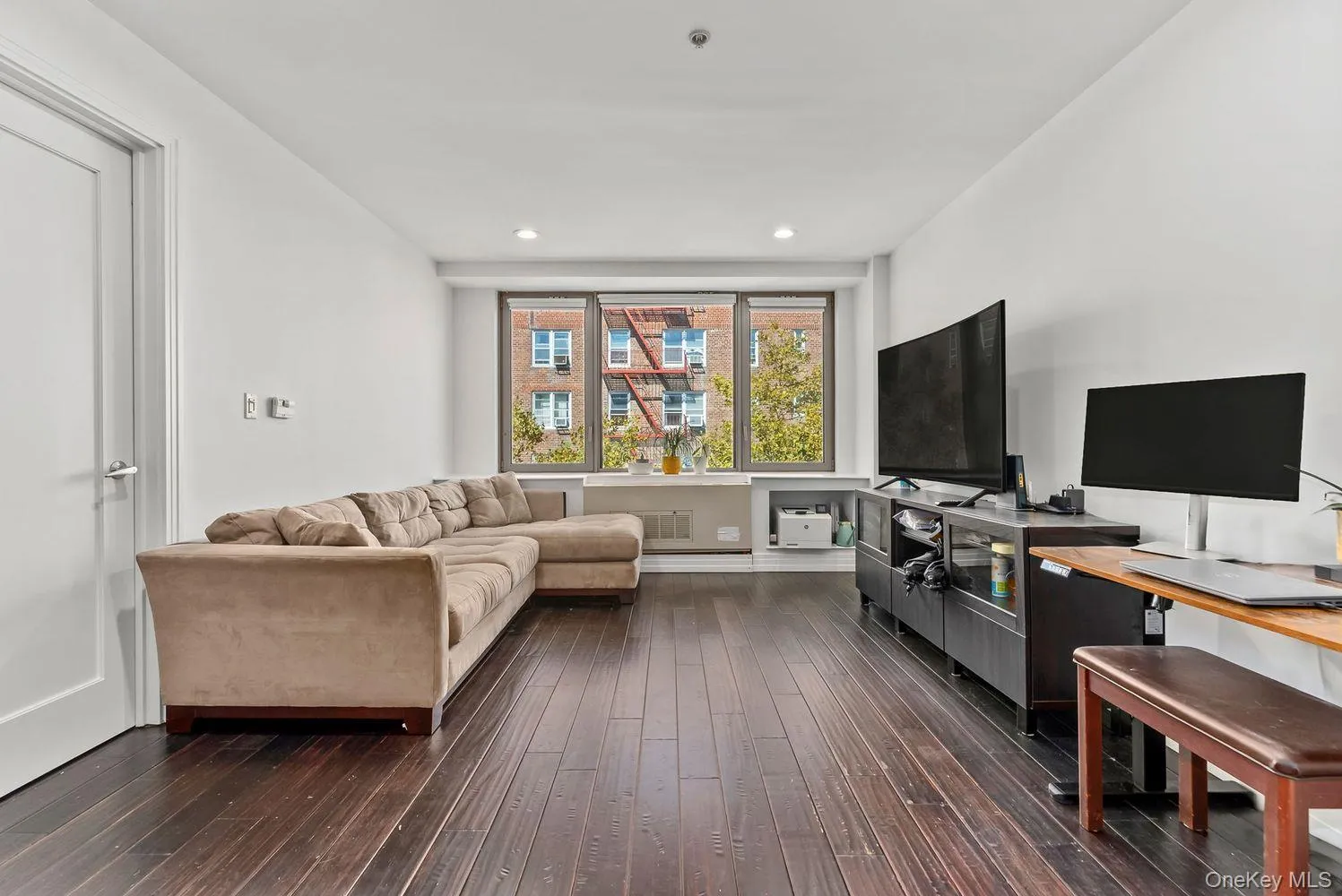 Living room with dark wood-style floors and recessed lighting Living room with dark wood-style floors and recessed lighting