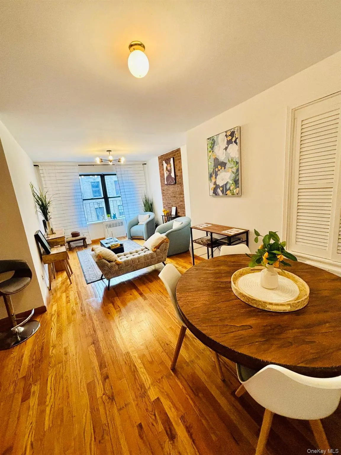 Dining space featuring light wood-style floors and radiator heating unit Dining space featuring light wood-style floors and radiator heating unit