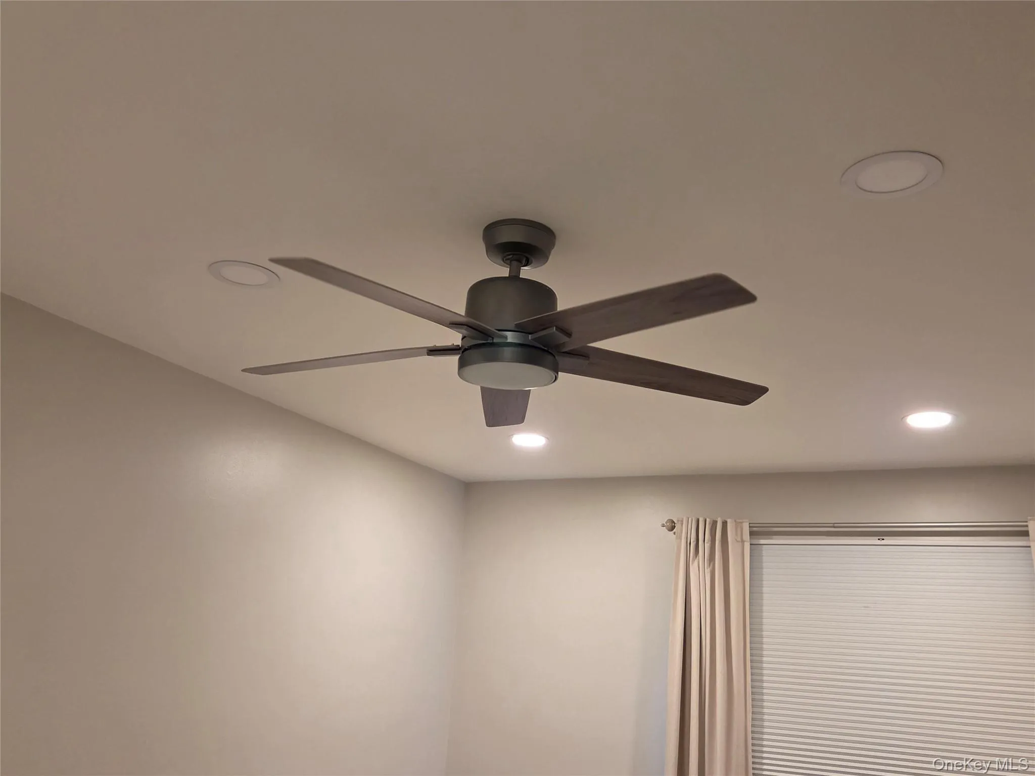 Detailed view of recessed lighting and a ceiling fan Detailed view of recessed lighting and a ceiling fan