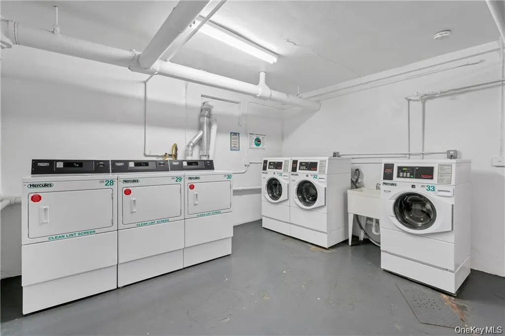 Community laundry featuring washing machine and dryer Community laundry featuring washing machine and dryer