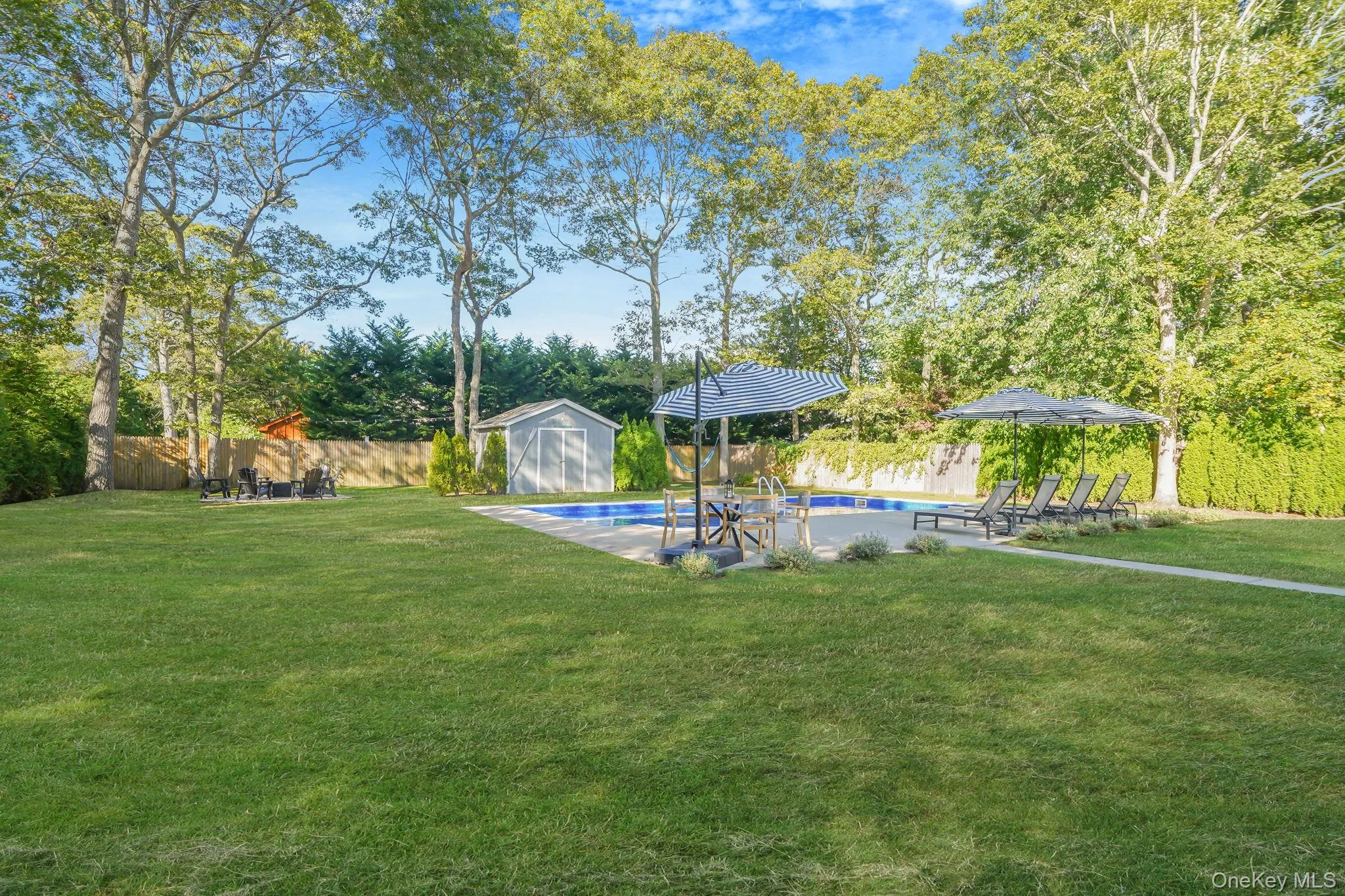 Fenced backyard featuring view of wooded area and a shed Fenced backyard featuring view of wooded area and a shed