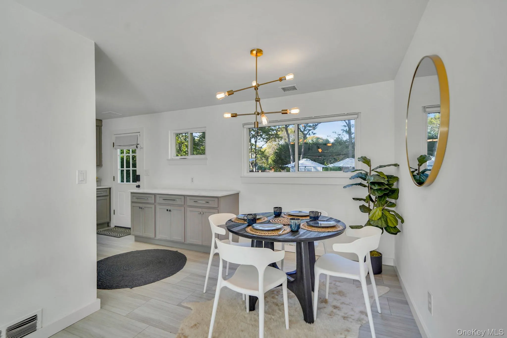 Dining area featuring light wood-style flooring and a chandelier Dining area featuring light wood-style flooring and a chandelier