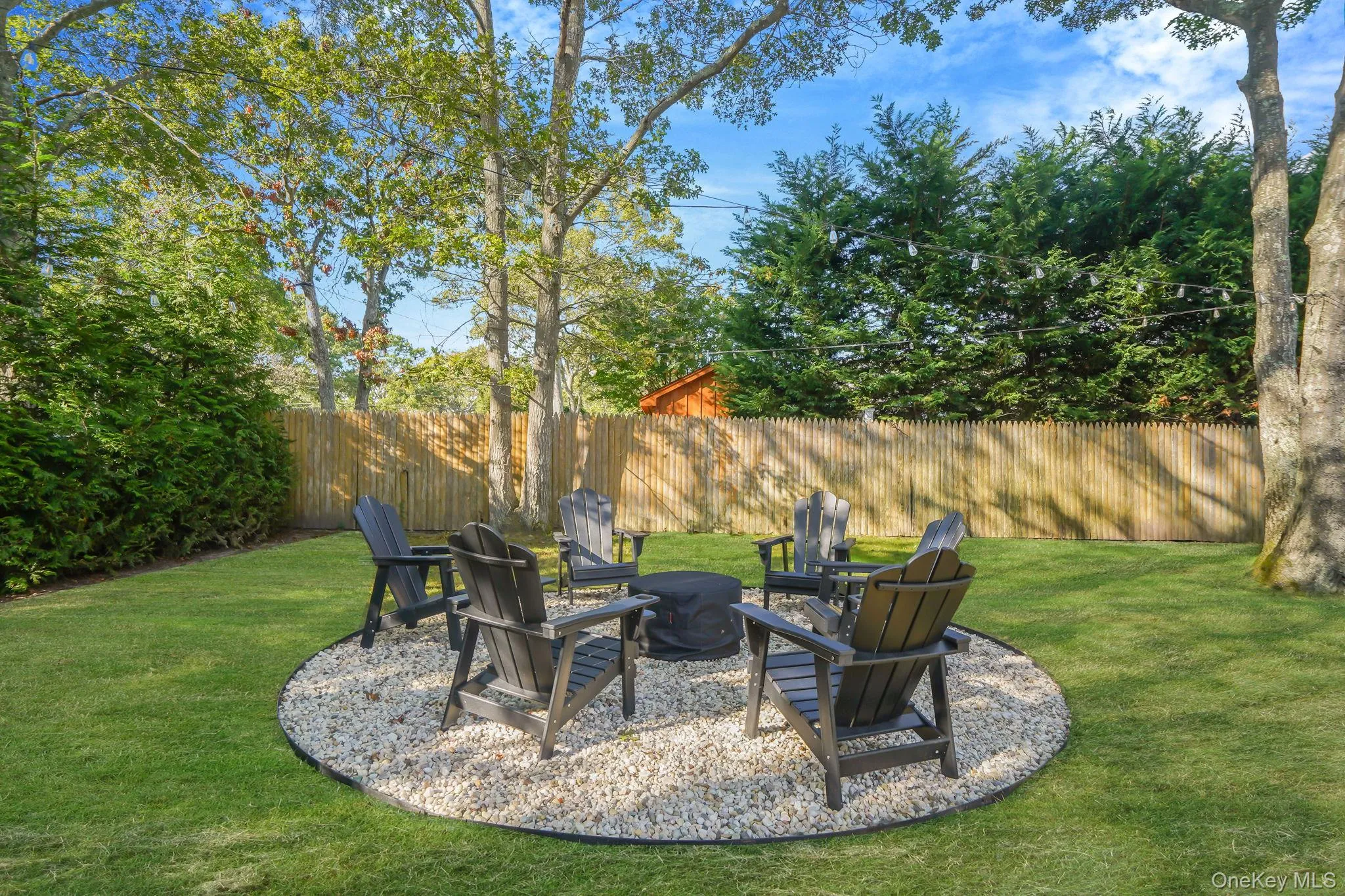 View of yard featuring an outdoor fire pit and a patio area View of yard featuring an outdoor fire pit and a patio area