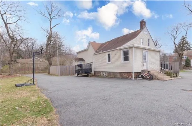 View of side of home featuring a chimney View of side of home featuring a chimney