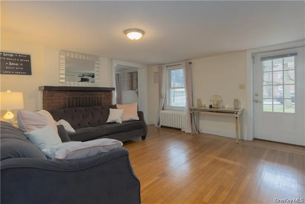 Living room with hardwood / wood-style flooring and radiator Living room with hardwood / wood-style flooring and radiator