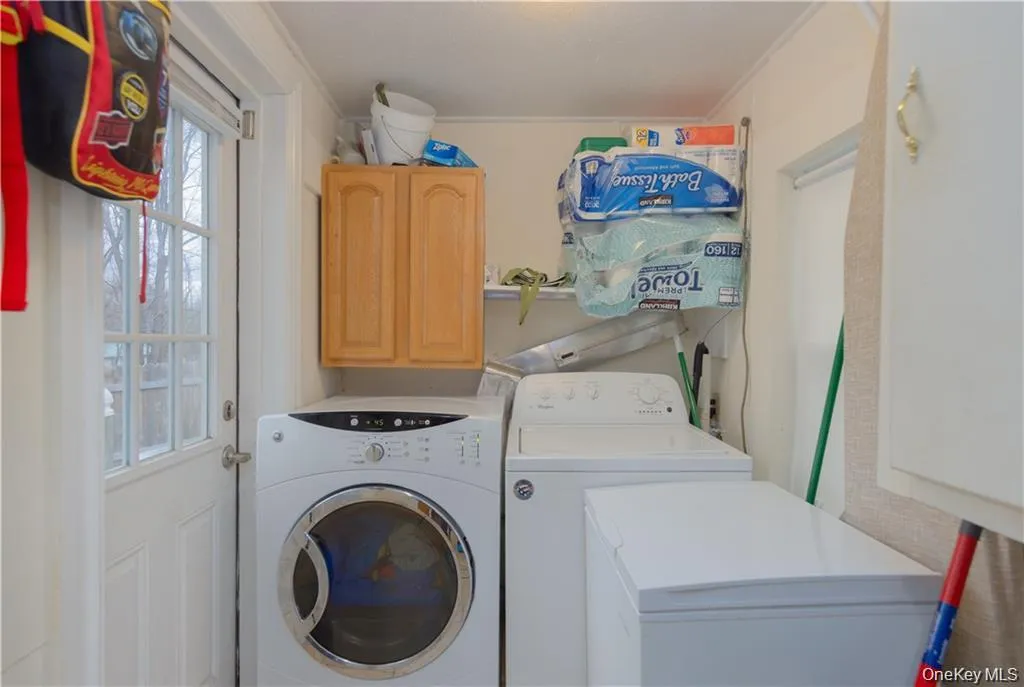 Laundry area with cabinet space and separate washer and dryer Laundry area with cabinet space and separate washer and dryer