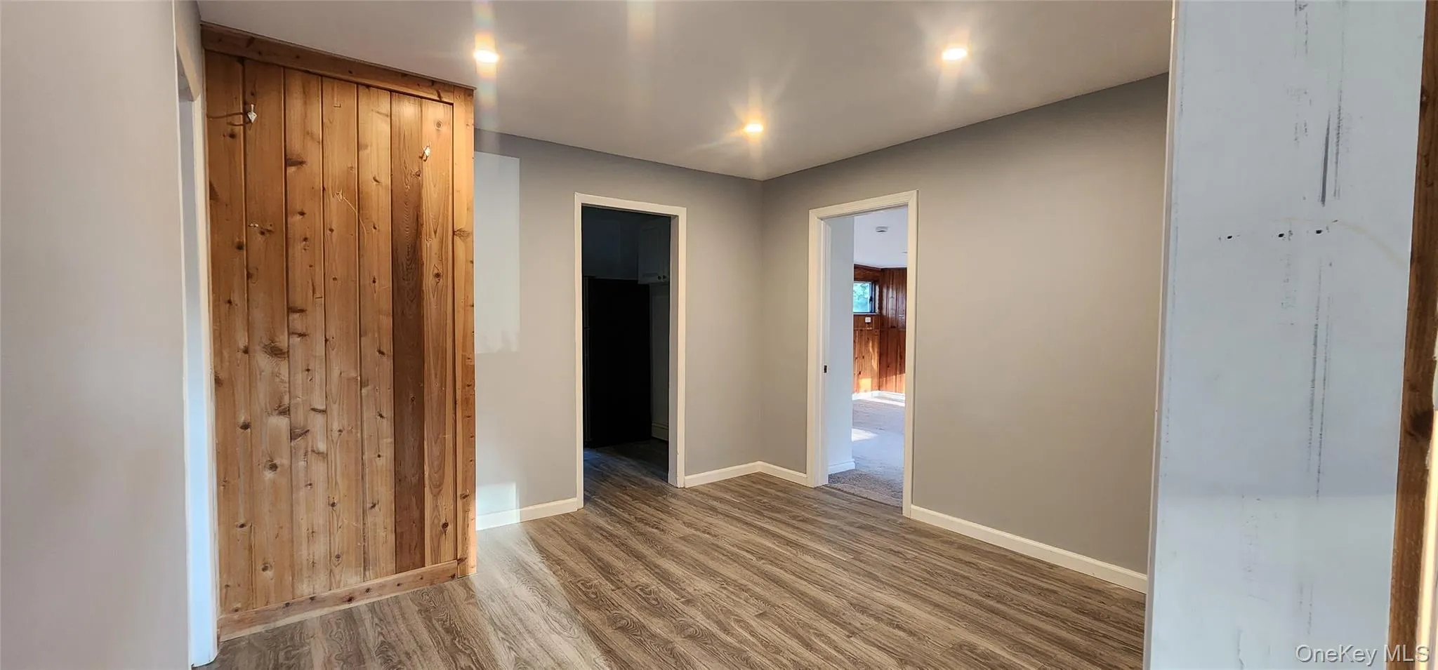 Hallway with wood finished floors and recessed lighting Hallway with wood finished floors and recessed lighting