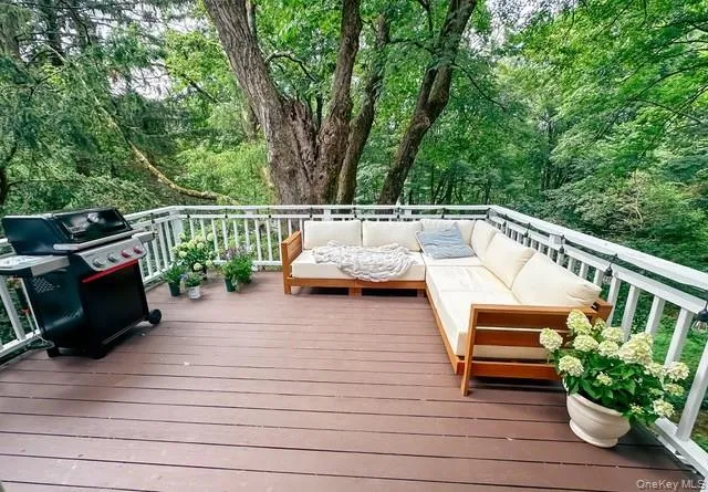 Wooden terrace with outdoor lounge area and a grill Wooden terrace with outdoor lounge area and a grill