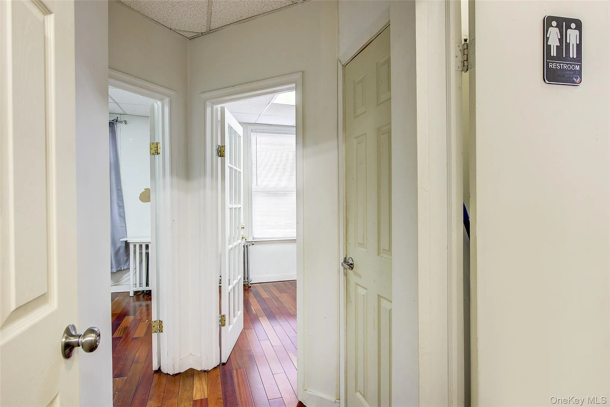 Corridor with dark wood-style flooring and baseboards Corridor with dark wood-style flooring and baseboards