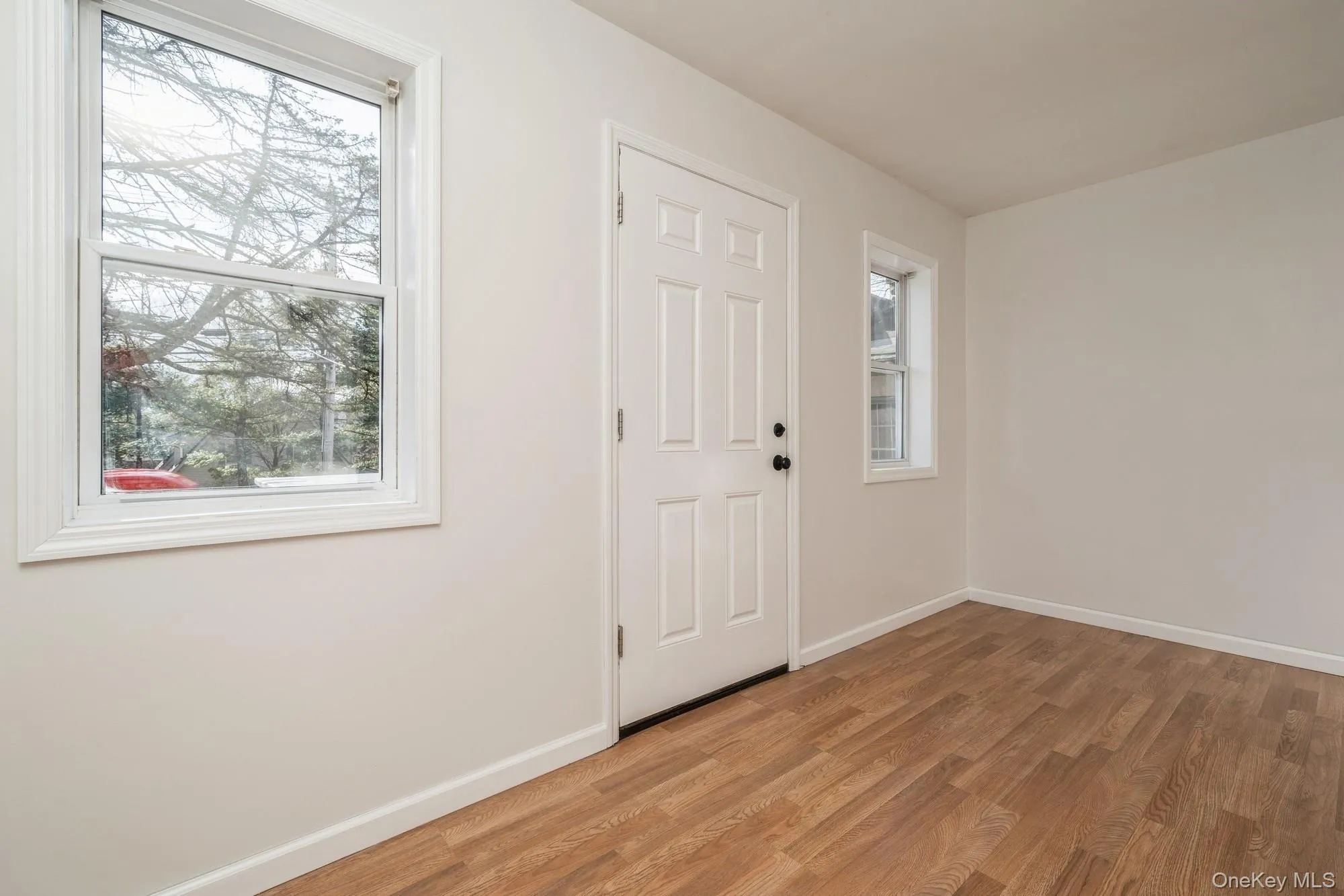 Foyer entrance featuring baseboards and light wood-style floors Foyer entrance featuring baseboards and light wood-style floors