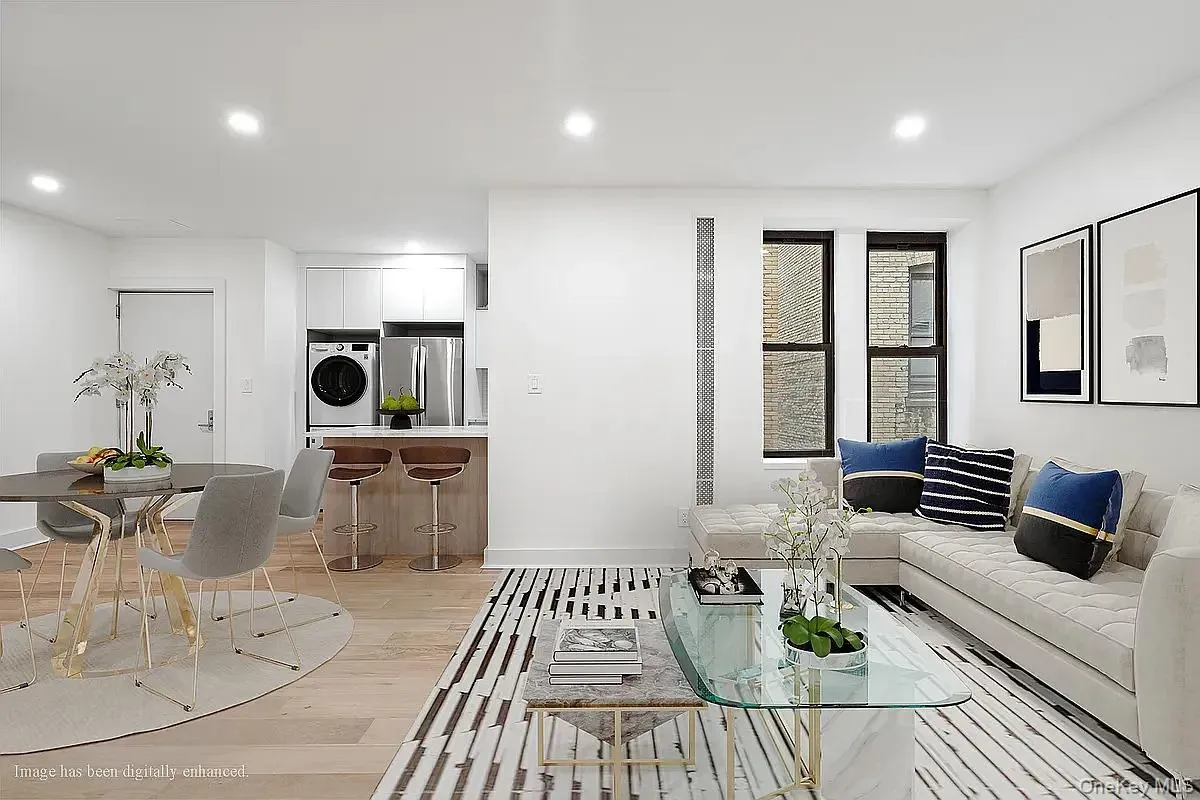 Living room featuring recessed lighting, light wood-style flooring, and washer / clothes dryer Living room featuring recessed lighting, light wood-style flooring, and washer / clothes dryer