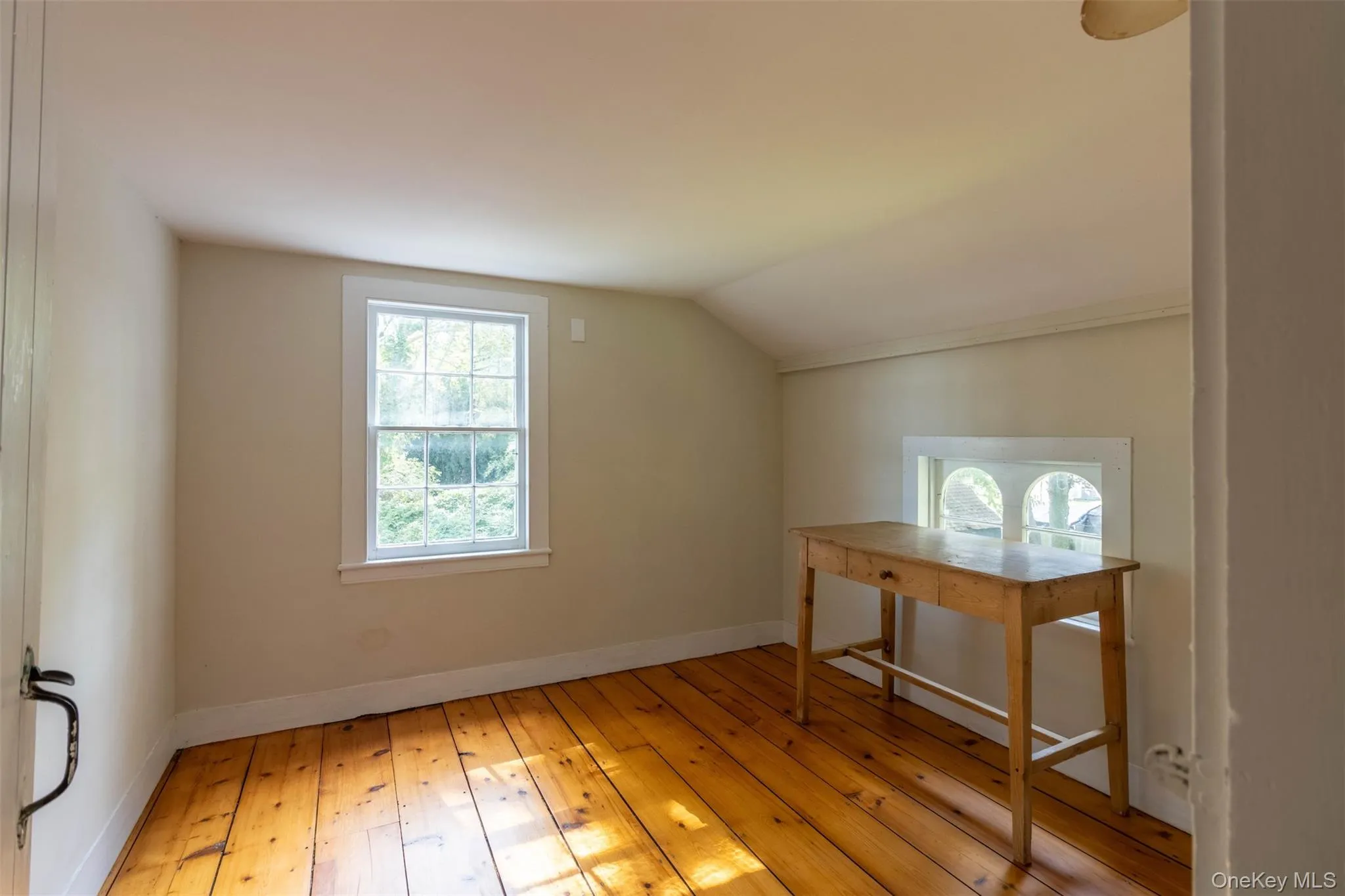 Additional living space featuring light wood-type flooring and vaulted ceiling Additional living space featuring light wood-type flooring and vaulted ceiling