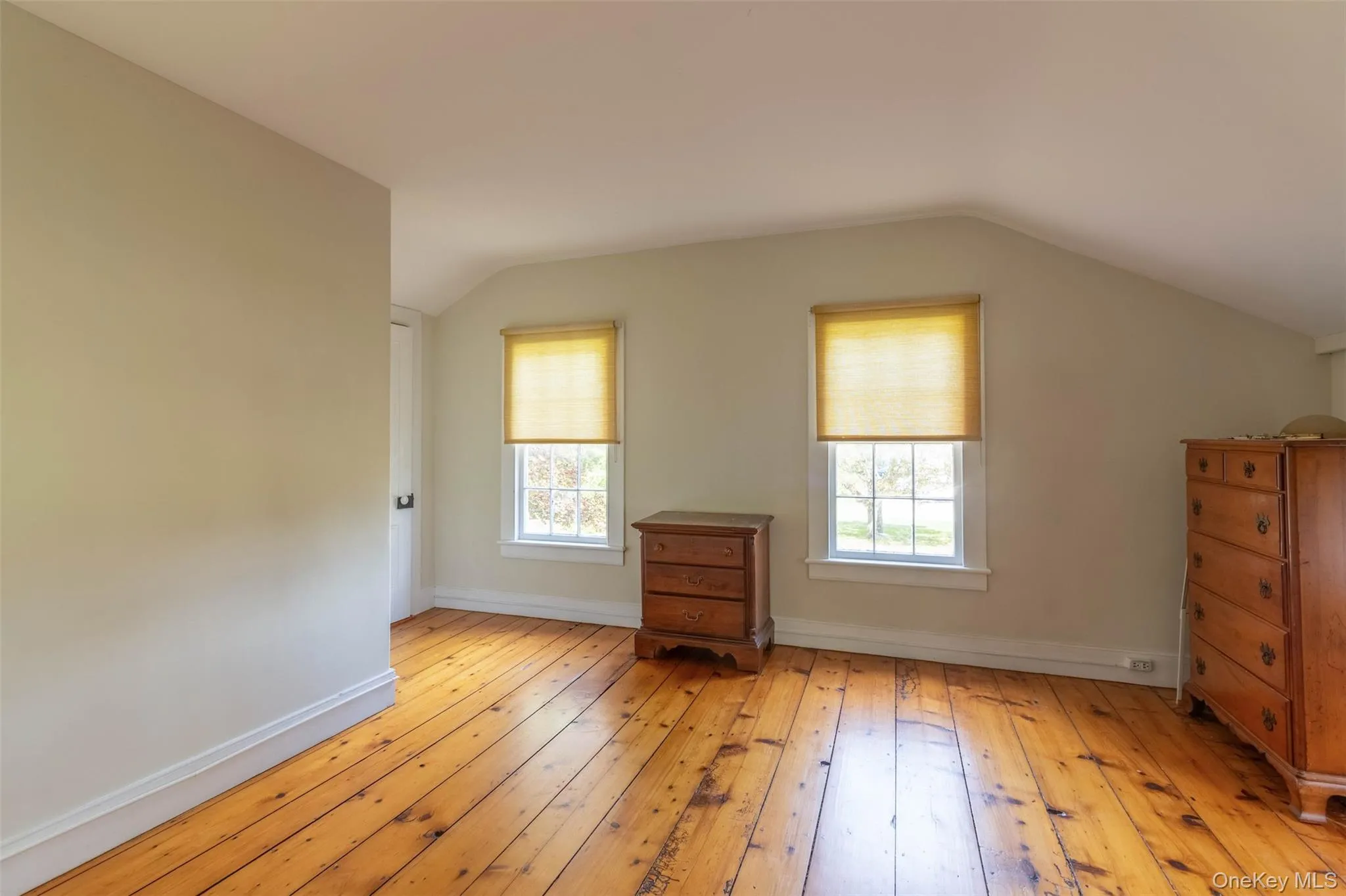 Bonus room with light wood finished floors and vaulted ceiling Bonus room with light wood finished floors and vaulted ceiling