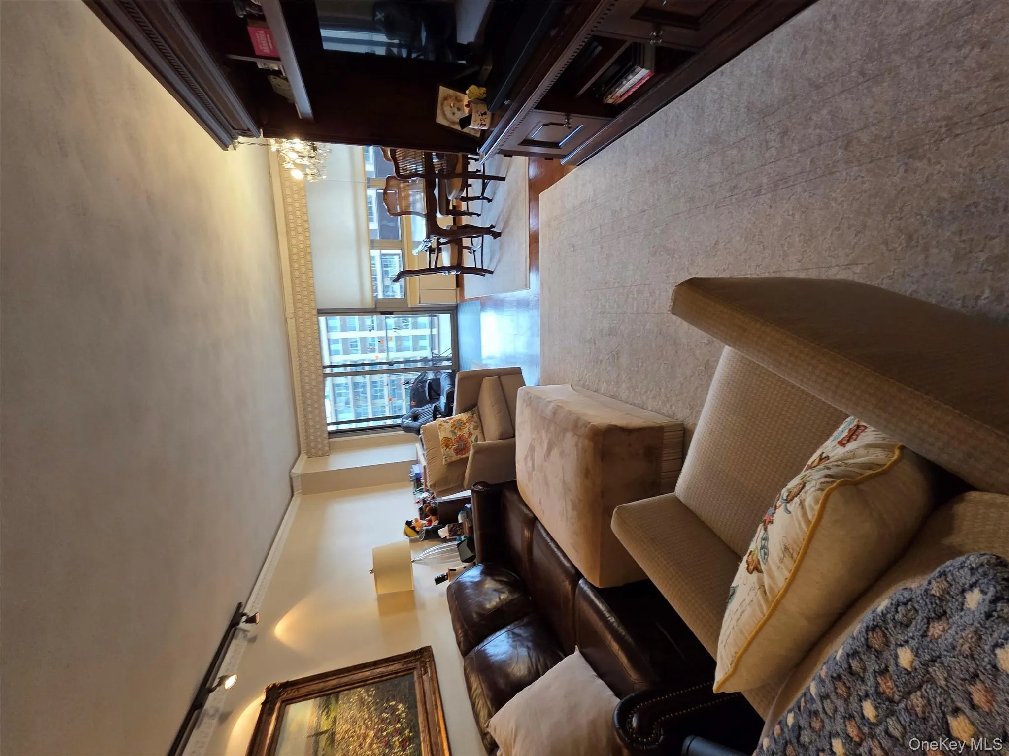Living area with track lighting, crown molding, and a chandelier Living area with track lighting, crown molding, and a chandelier