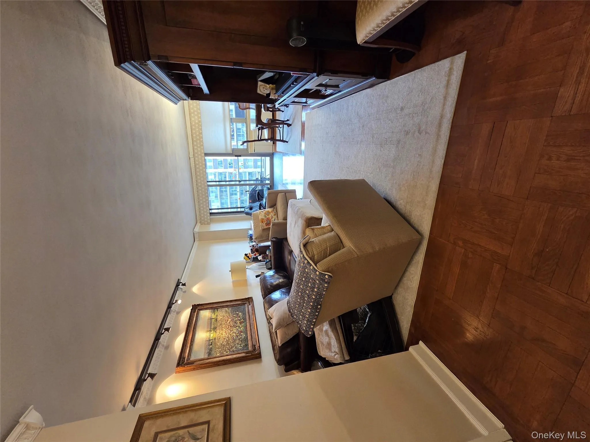 Living room with rail lighting and a wall of windows Living room with rail lighting and a wall of windows