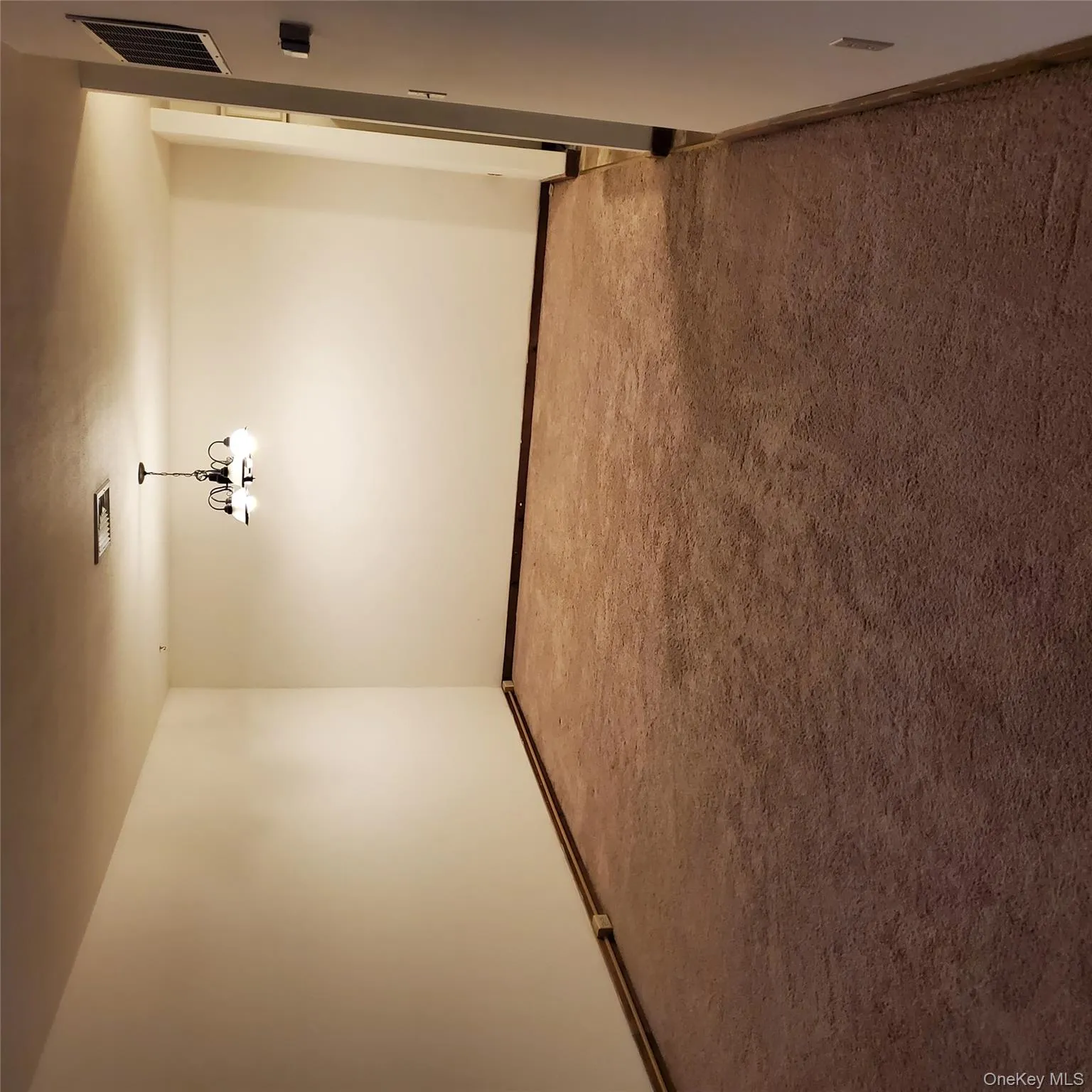 Unfurnished room featuring carpet and a chandelier Unfurnished room featuring carpet and a chandelier