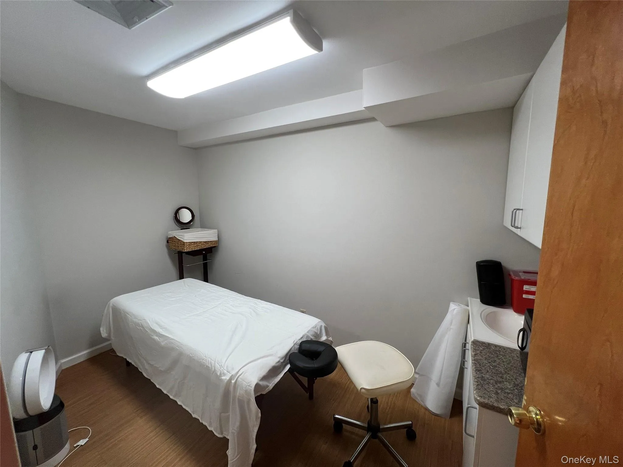 Bedroom featuring wood finished floors and baseboards Bedroom featuring wood finished floors and baseboards