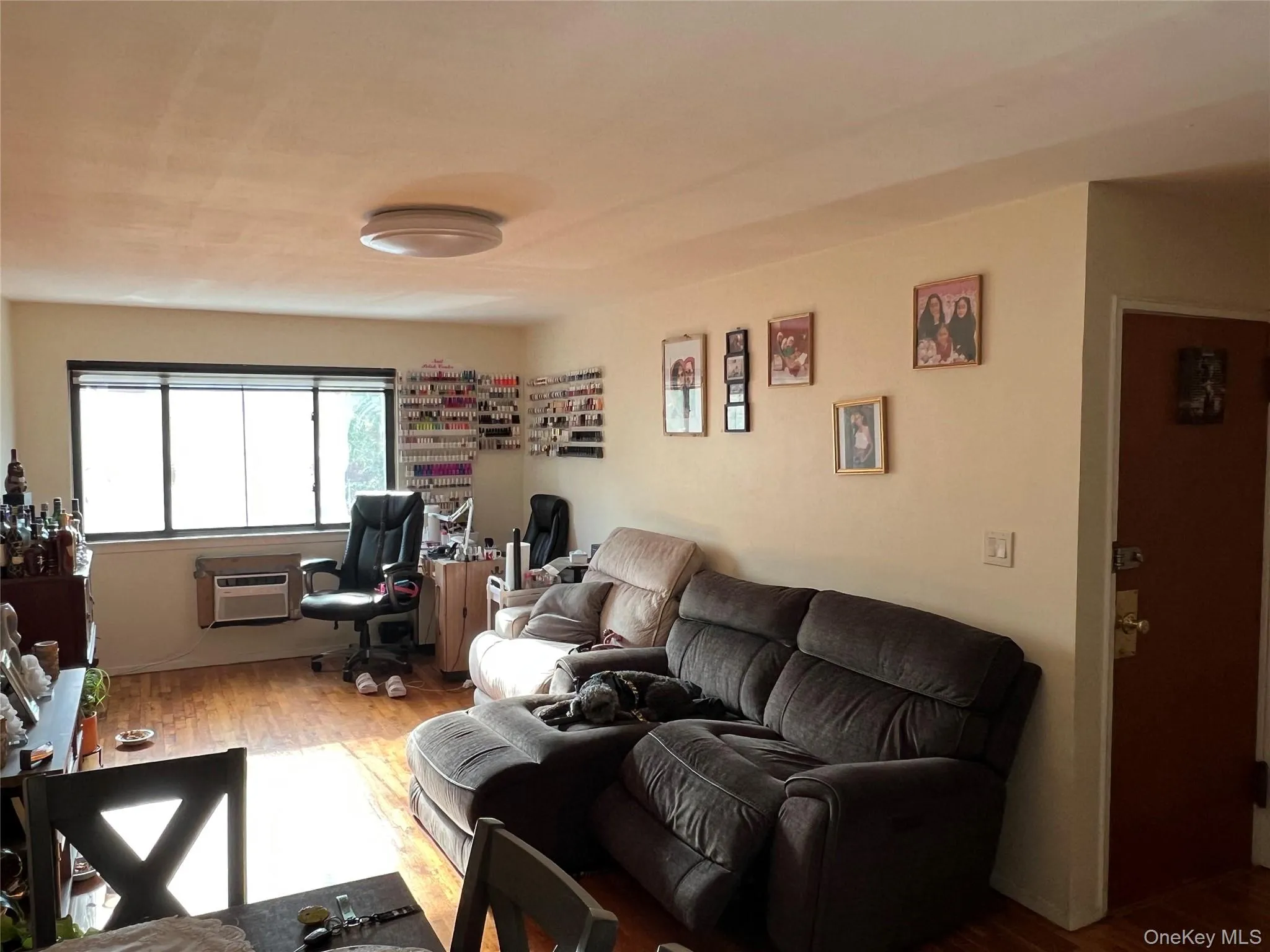 Living room with wood finished floors and an office area Living room with wood finished floors and an office area