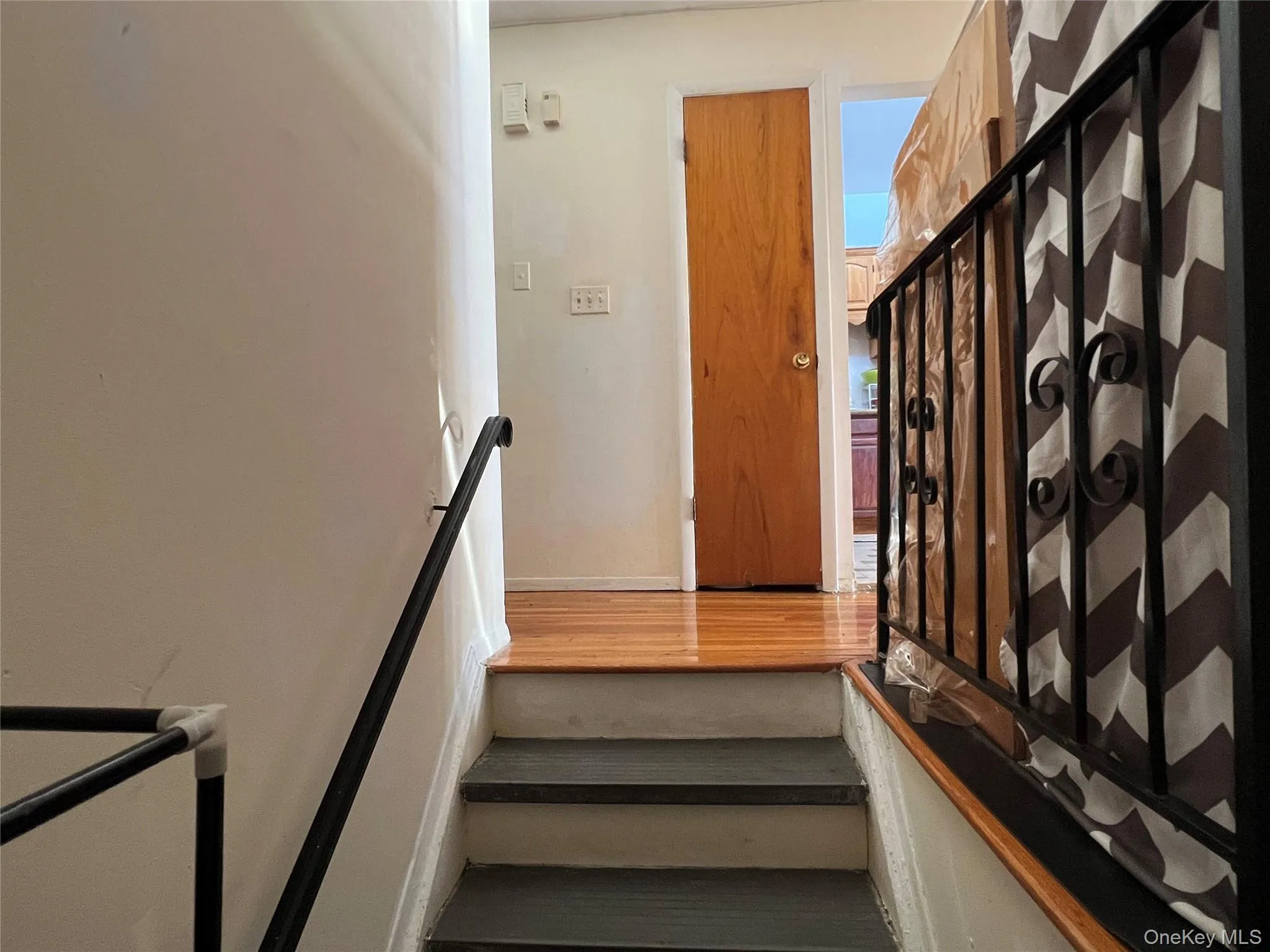Stairs featuring wood finished floors Stairs featuring wood finished floors