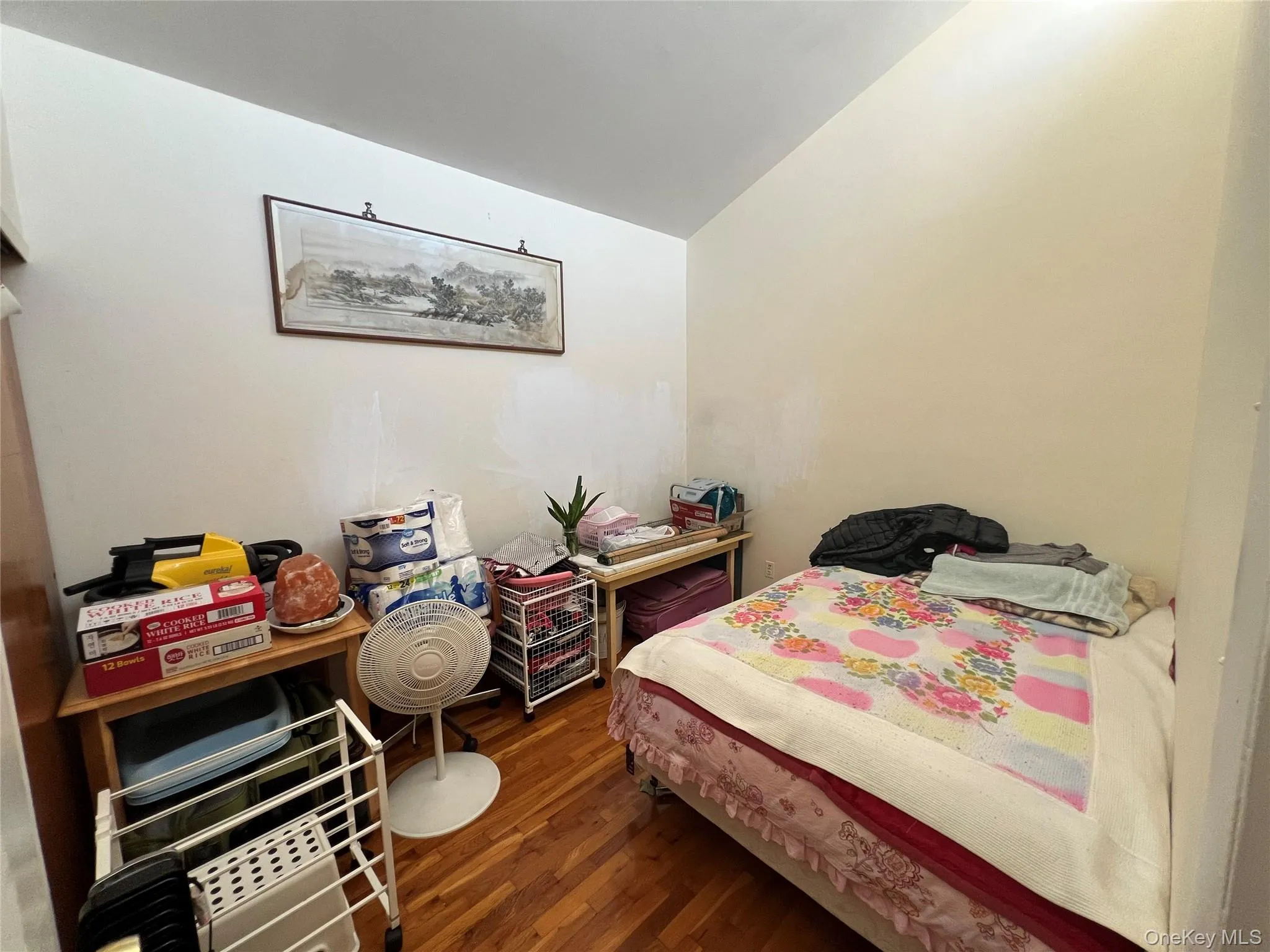 Bedroom with dark wood-style floors and lofted ceiling Bedroom with dark wood-style floors and lofted ceiling