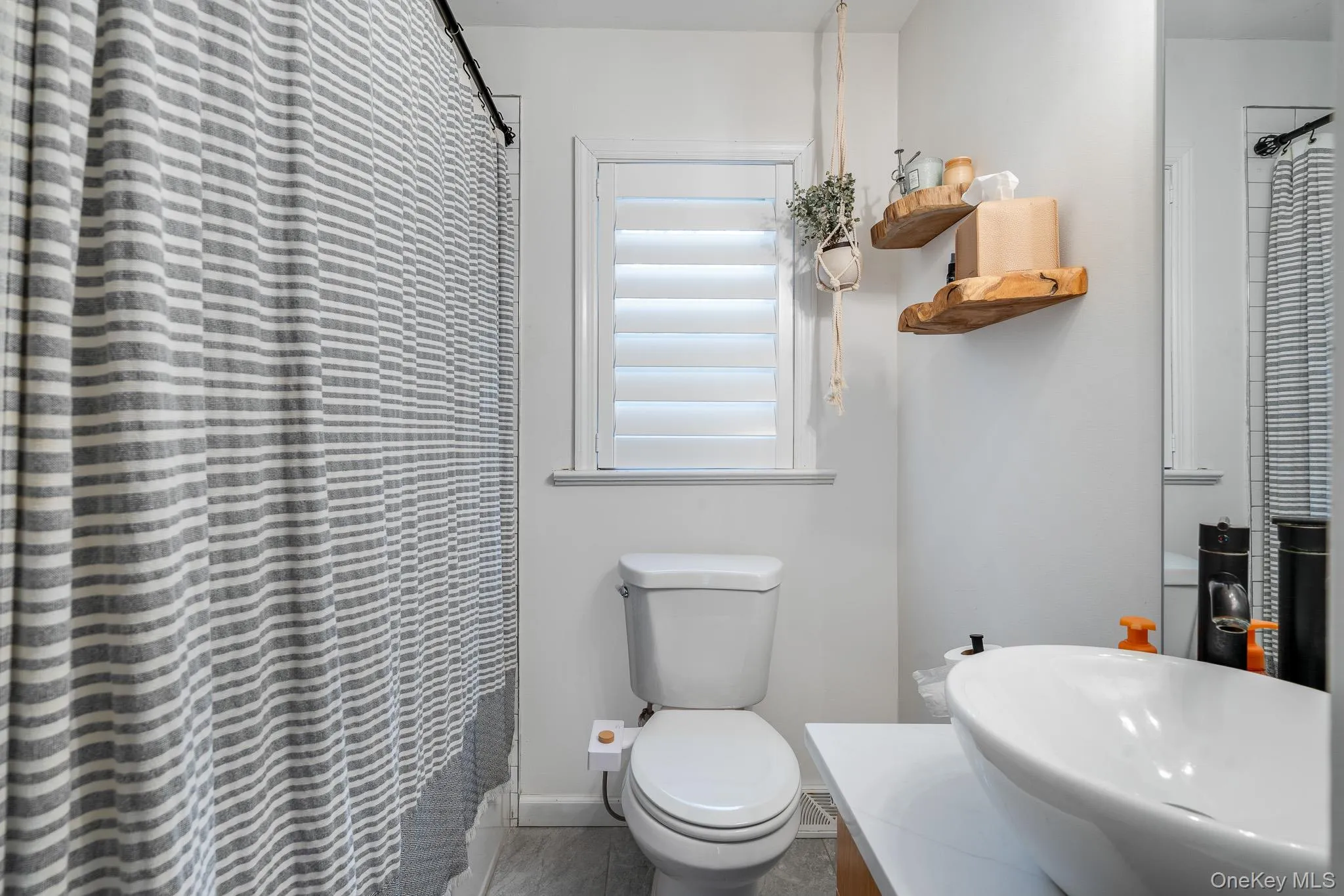 Full bathroom with curtained shower and vanity Full bathroom with curtained shower and vanity