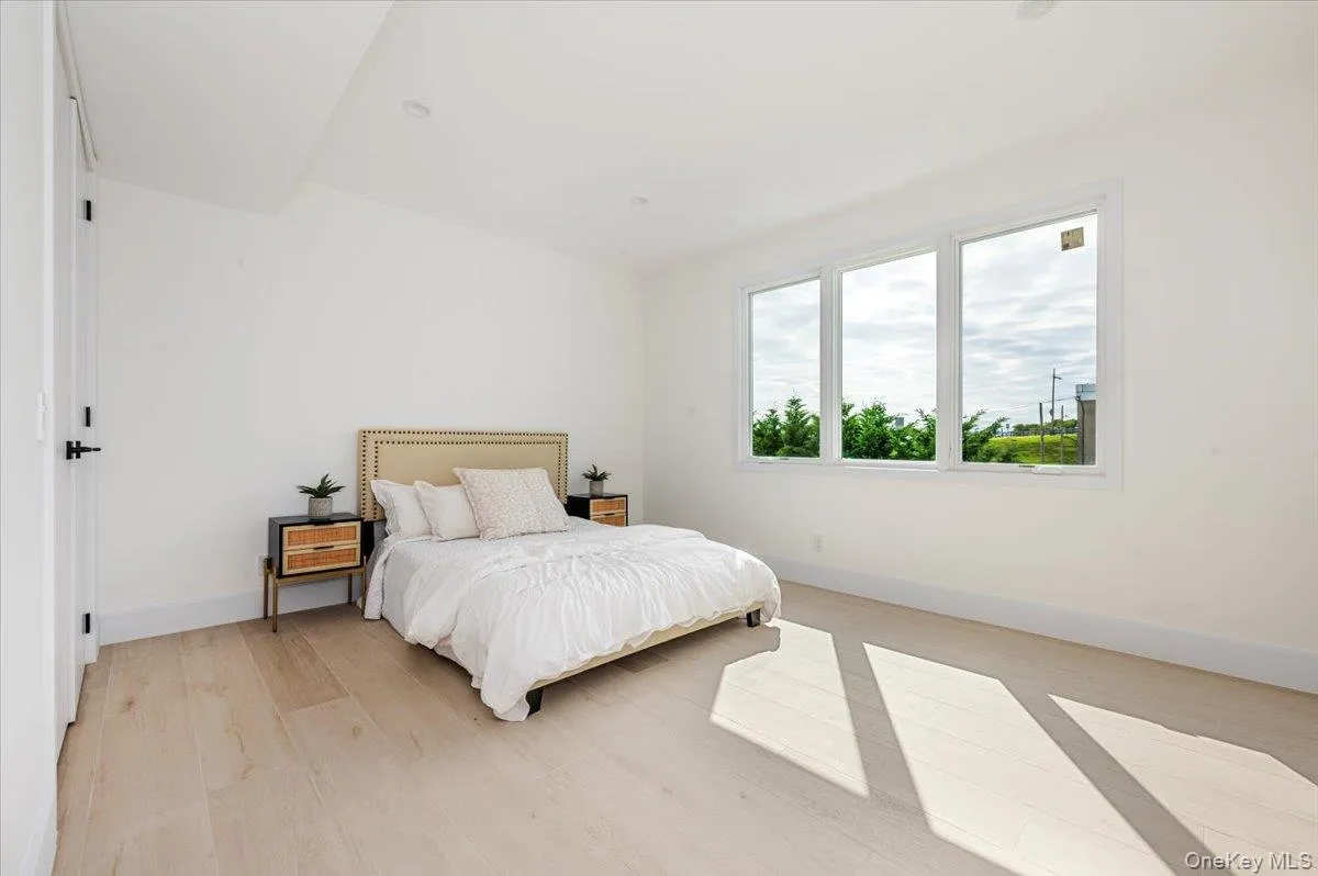 Bedroom with baseboards and light wood finished floors Bedroom with baseboards and light wood finished floors