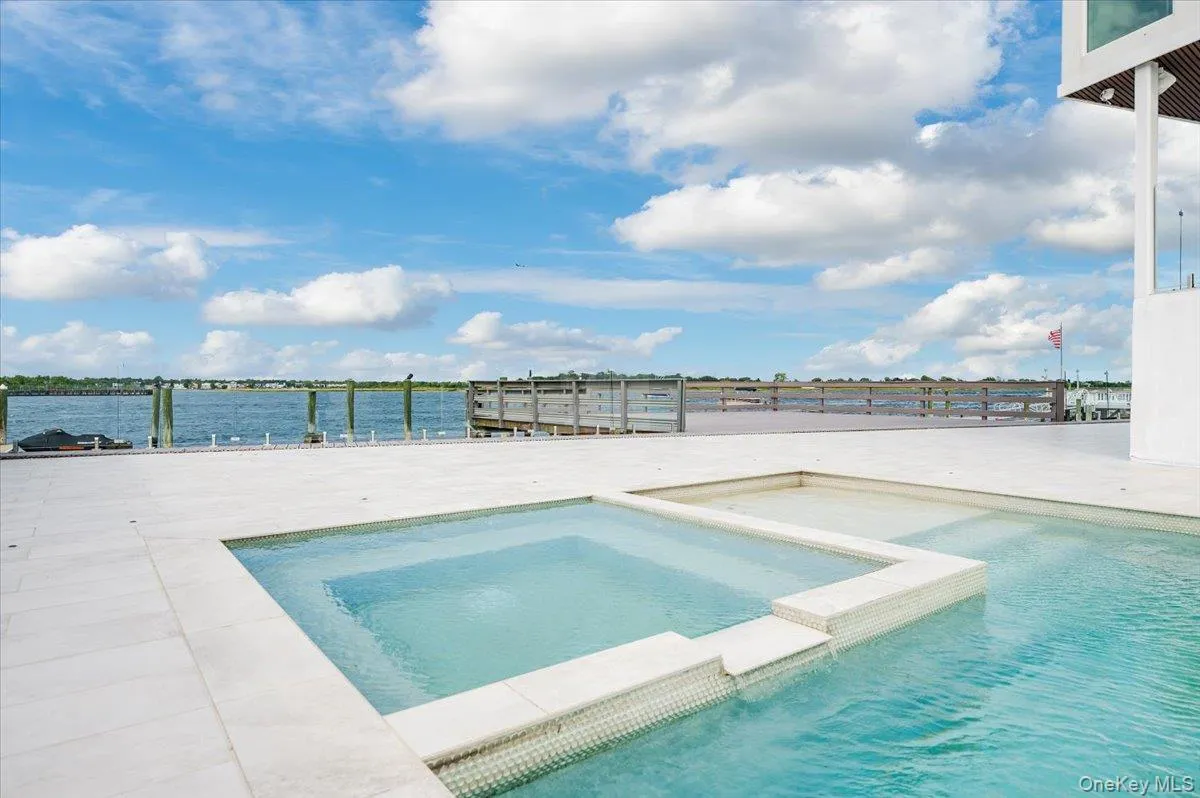 View of pool with a pool with connected hot tub and a water view View of pool with a pool with connected hot tub and a water view