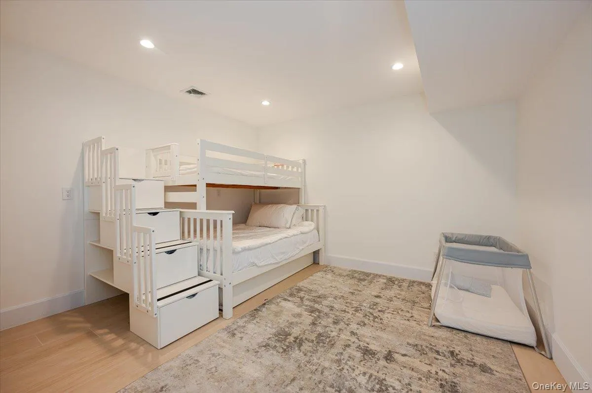 Bedroom with recessed lighting and light wood-style floors Bedroom with recessed lighting and light wood-style floors