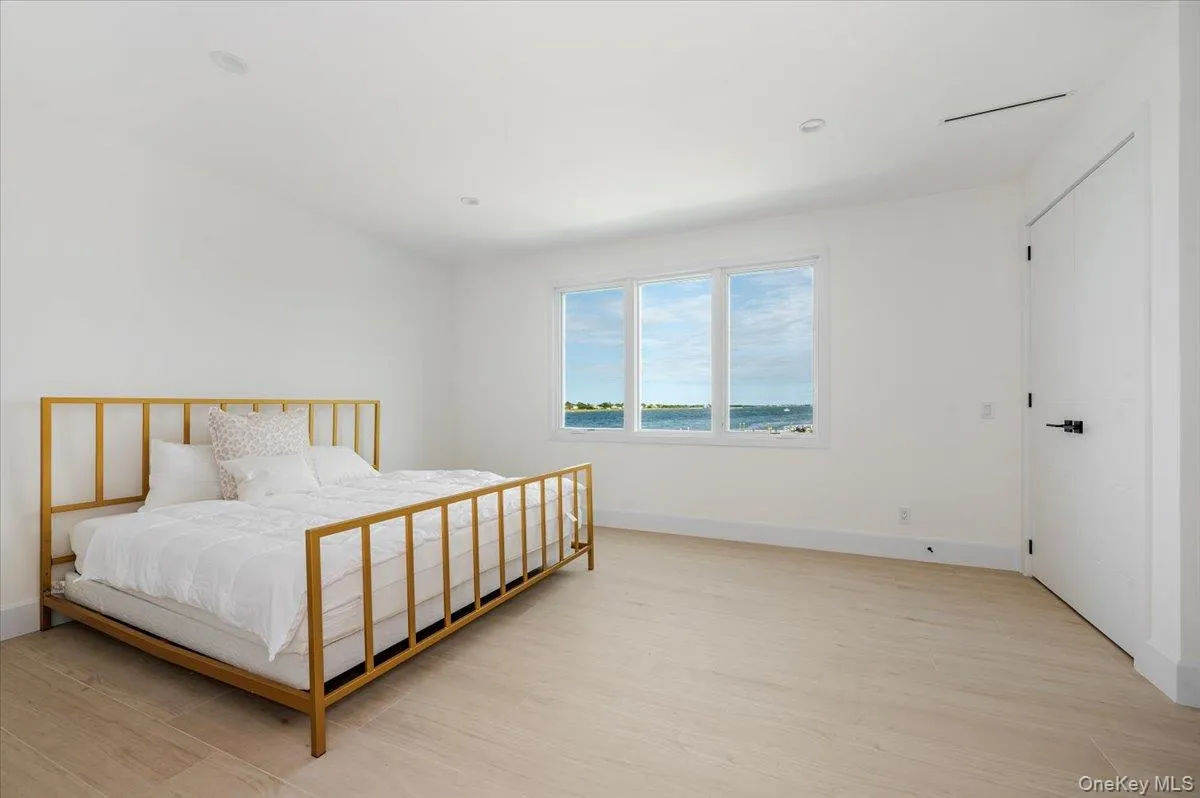 Bedroom featuring light wood-type flooring and baseboards Bedroom featuring light wood-type flooring and baseboards