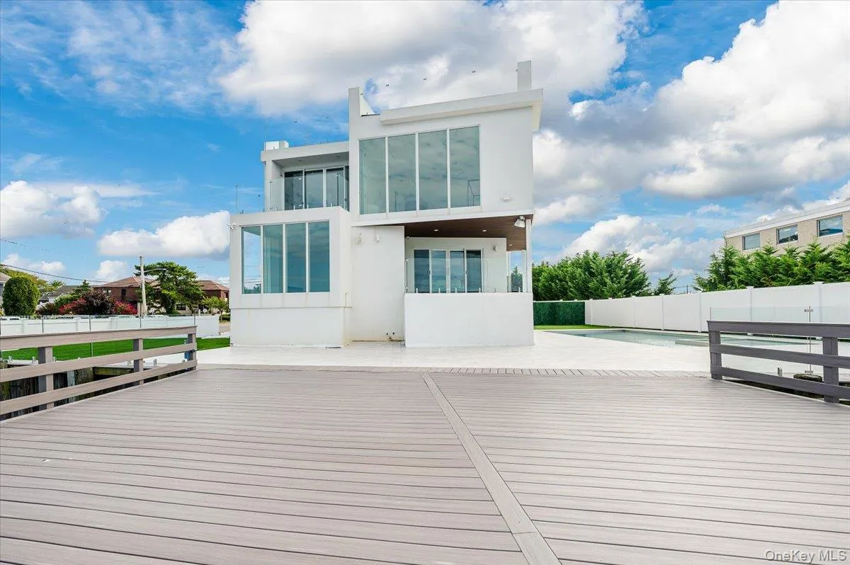 Wooden terrace with a fenced backyard and a patio Wooden terrace with a fenced backyard and a patio