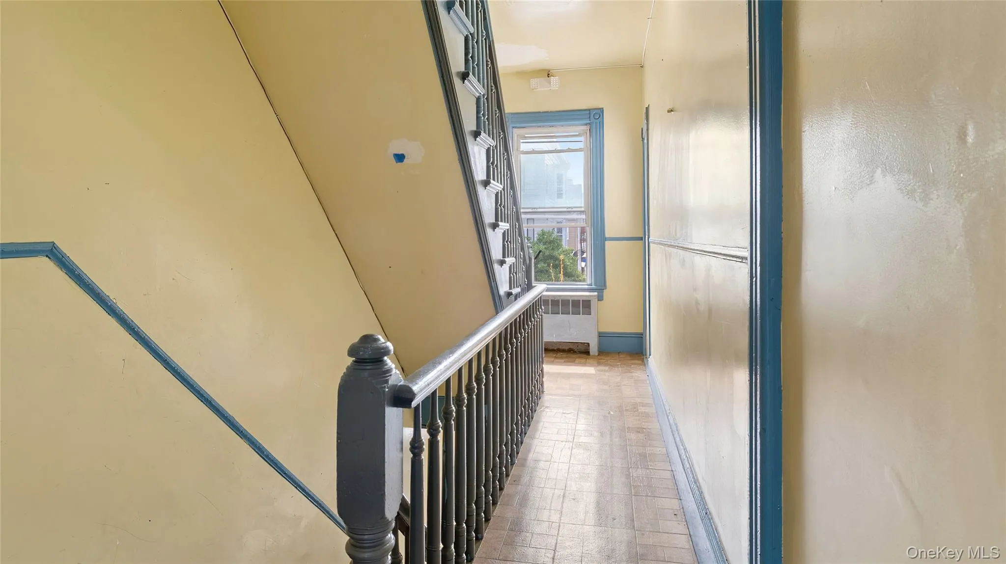 Hallway featuring radiator and an upstairs landing Hallway featuring radiator and an upstairs landing