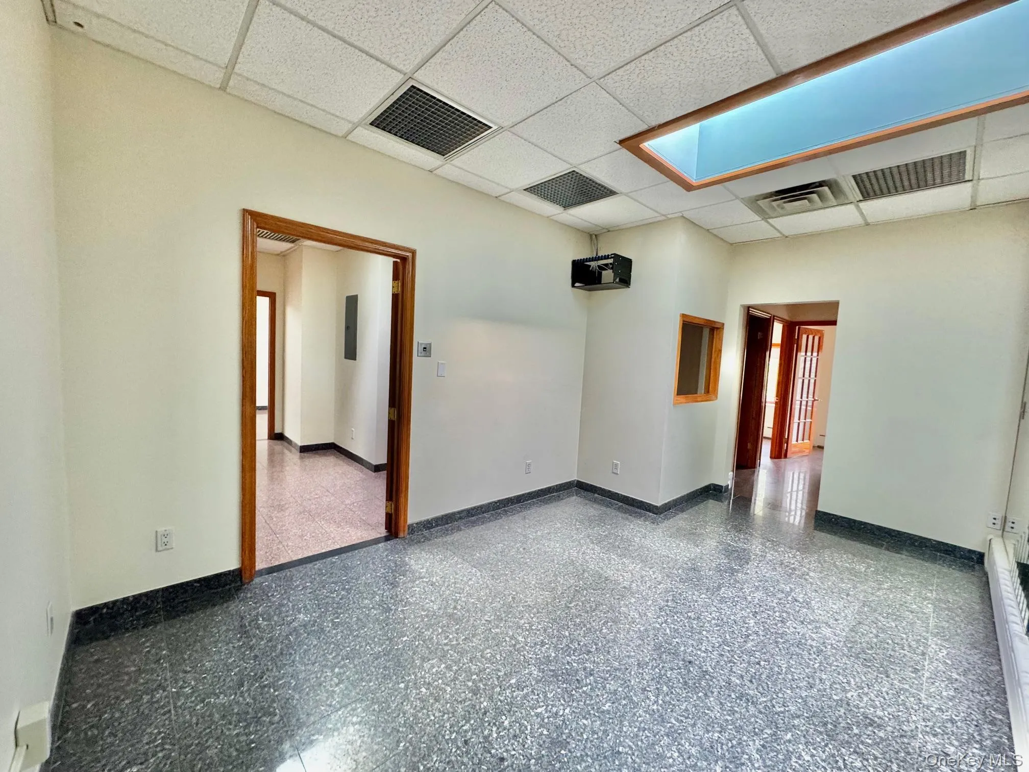 Unfurnished room featuring a drop ceiling and a baseboard heating unit Unfurnished room featuring a drop ceiling and a baseboard heating unit