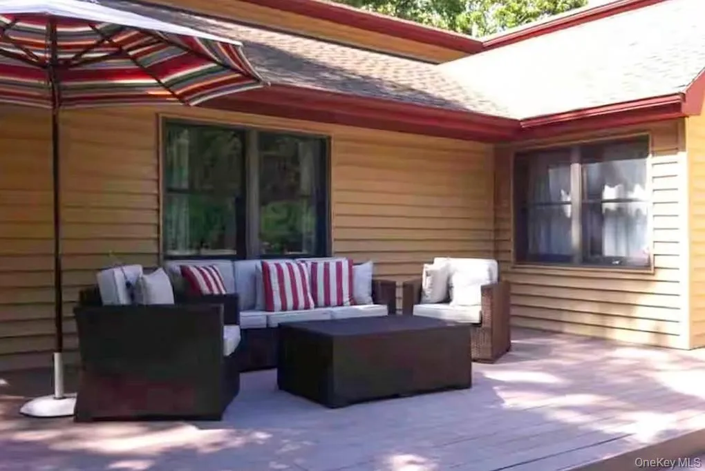 View of patio / terrace with outdoor lounge area and a wooden deck View of patio / terrace with outdoor lounge area and a wooden deck