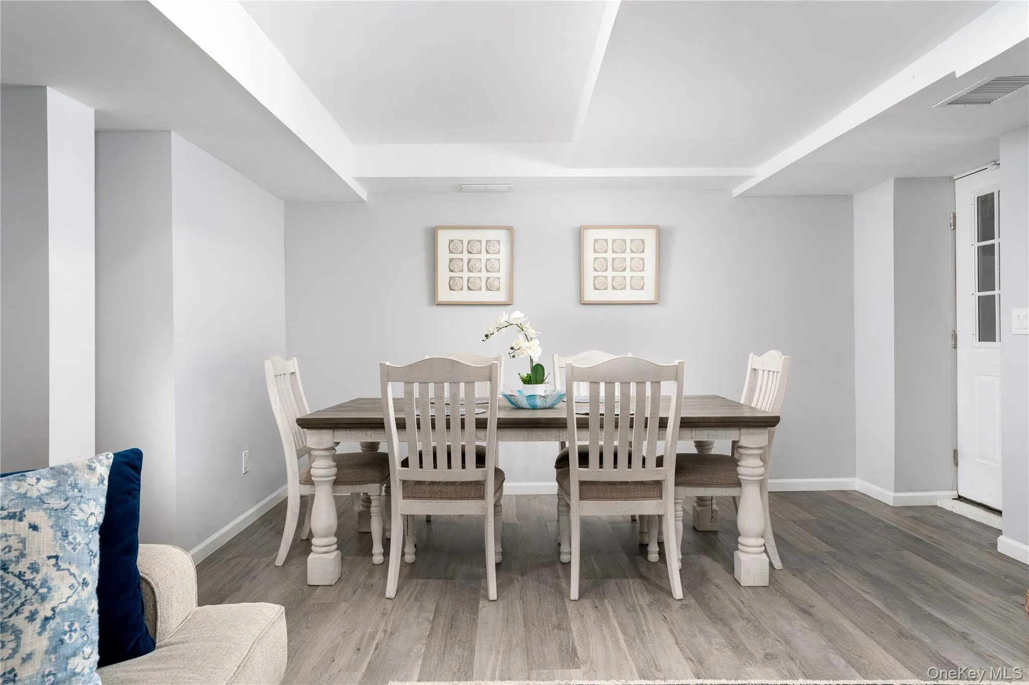 Dining room with light wood-style flooring and baseboards Dining room with light wood-style flooring and baseboards
