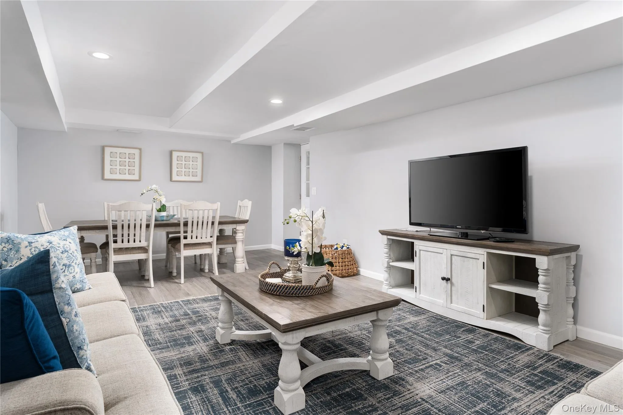 Living room featuring dark wood-type flooring and recessed lighting Living room featuring dark wood-type flooring and recessed lighting