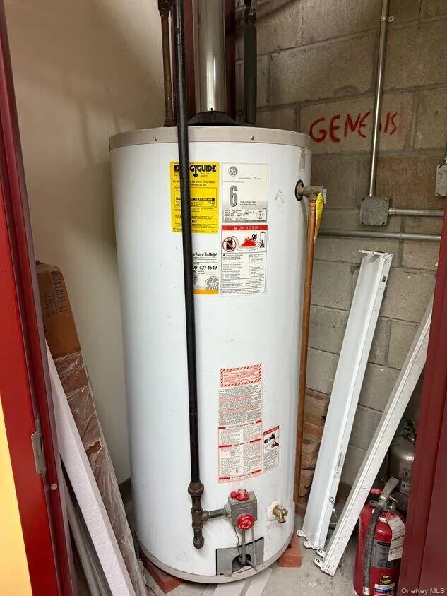 Utility room featuring gas water heater Utility room featuring gas water heater