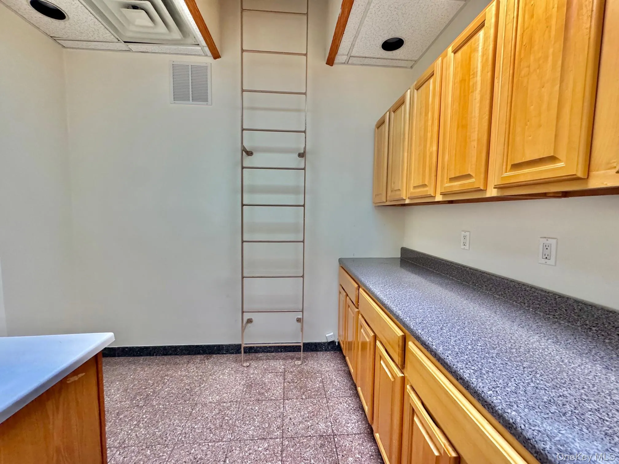 Kitchen featuring dark countertops and granite floors Kitchen featuring dark countertops and granite floors