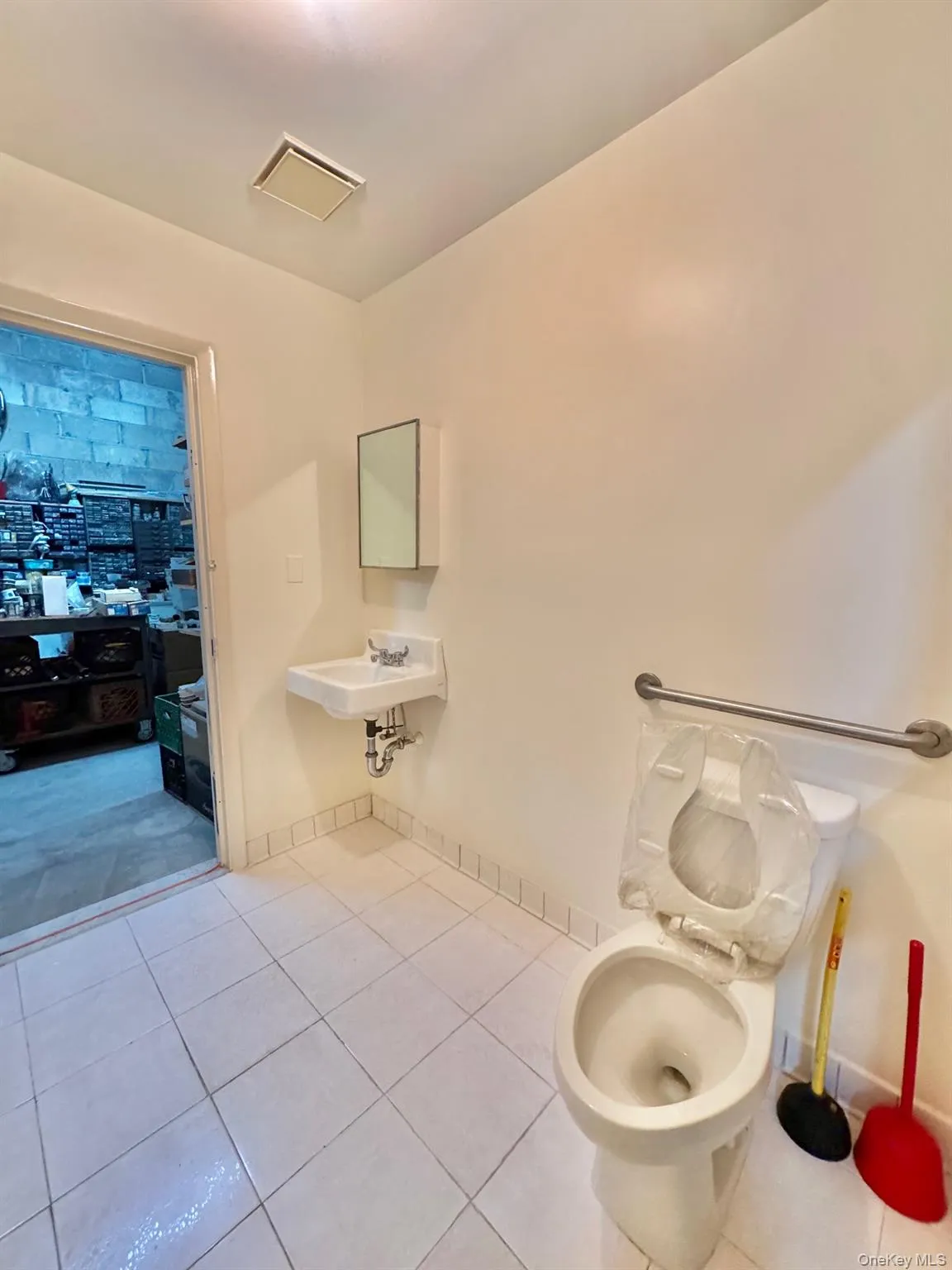 Bathroom with light tile patterned floors Bathroom with light tile patterned floors