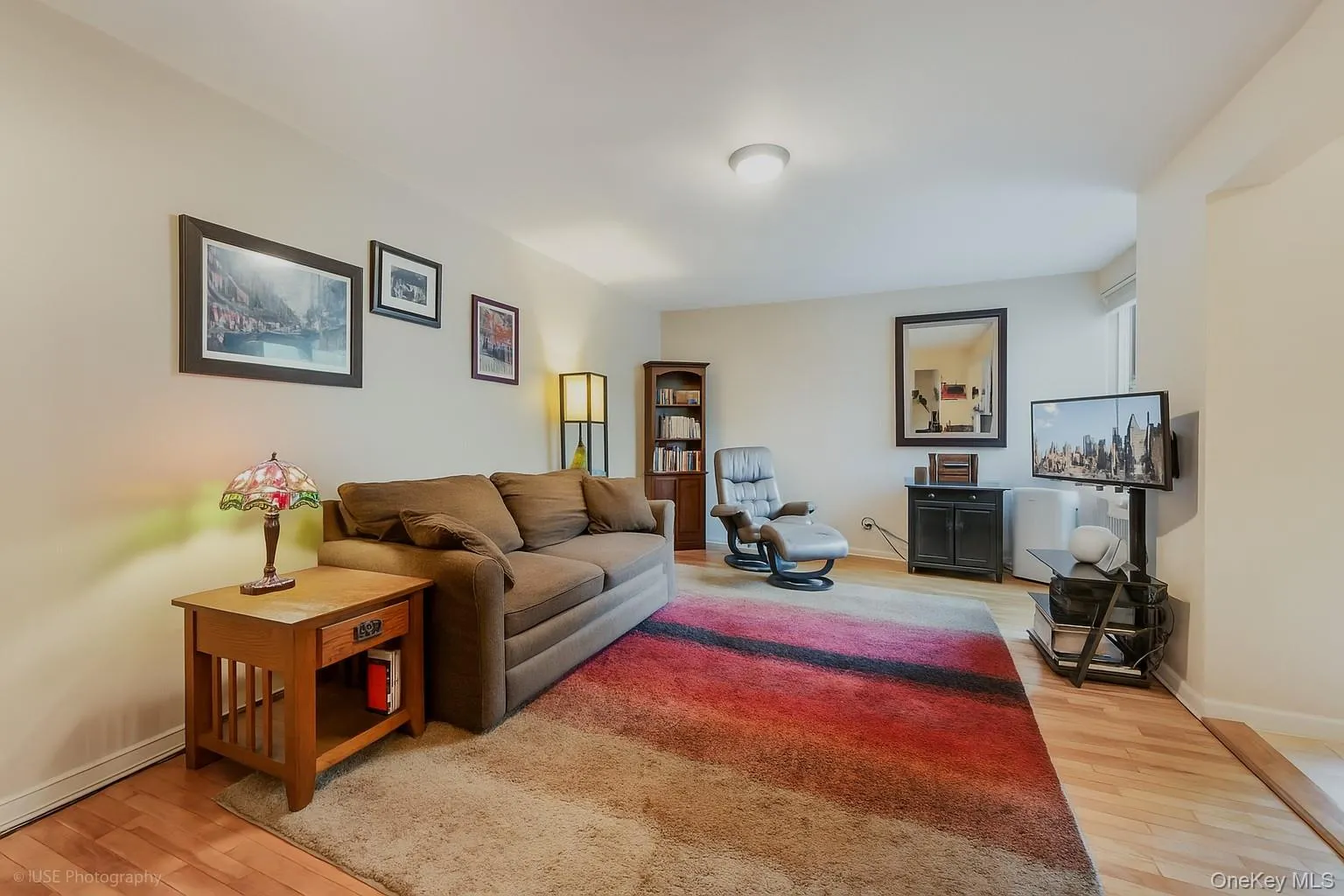 Living room with light wood-style flooring and baseboards Living room with light wood-style flooring and baseboards