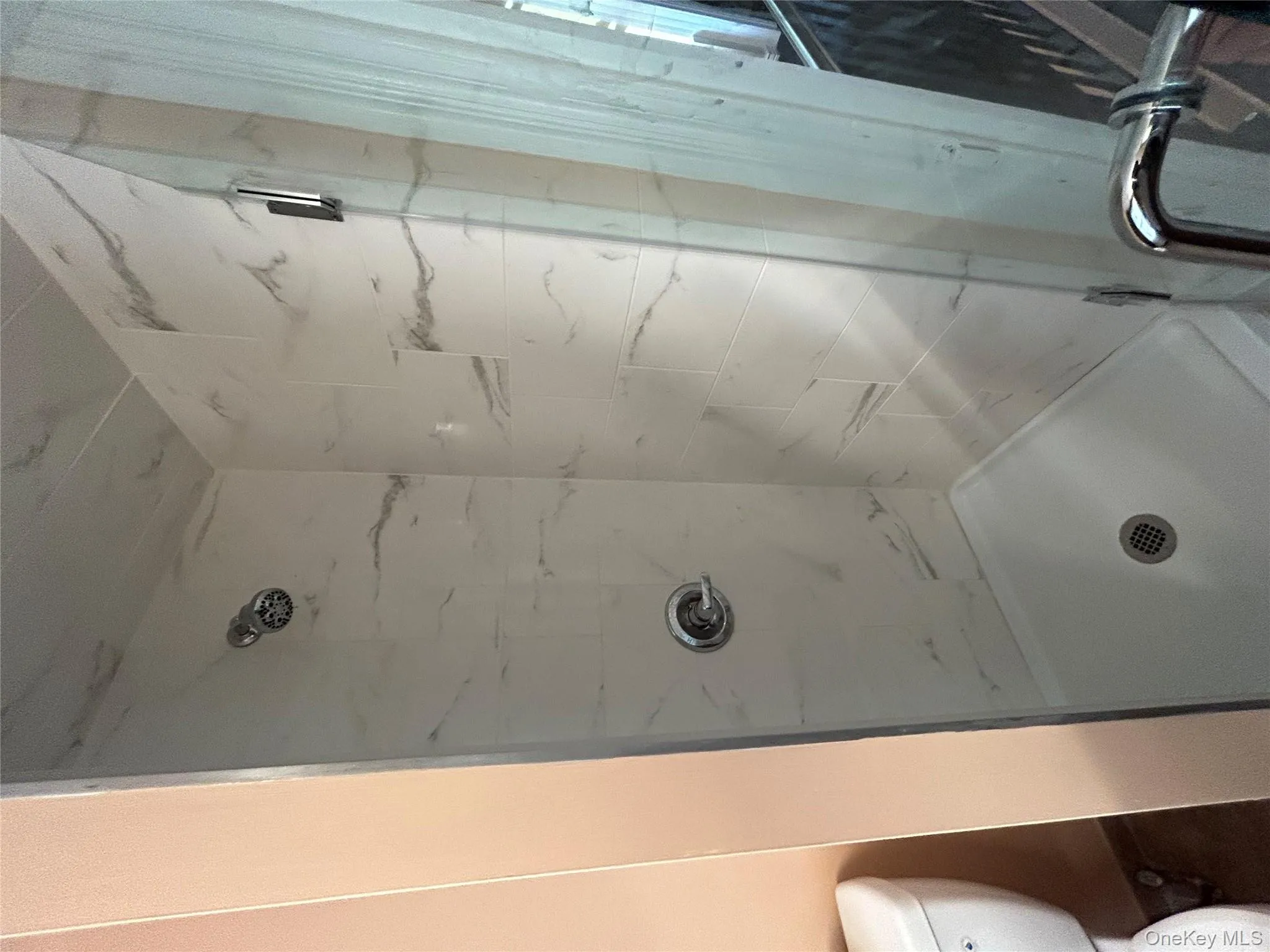 Bathroom with a marble finish shower and toilet Bathroom with a marble finish shower and toilet