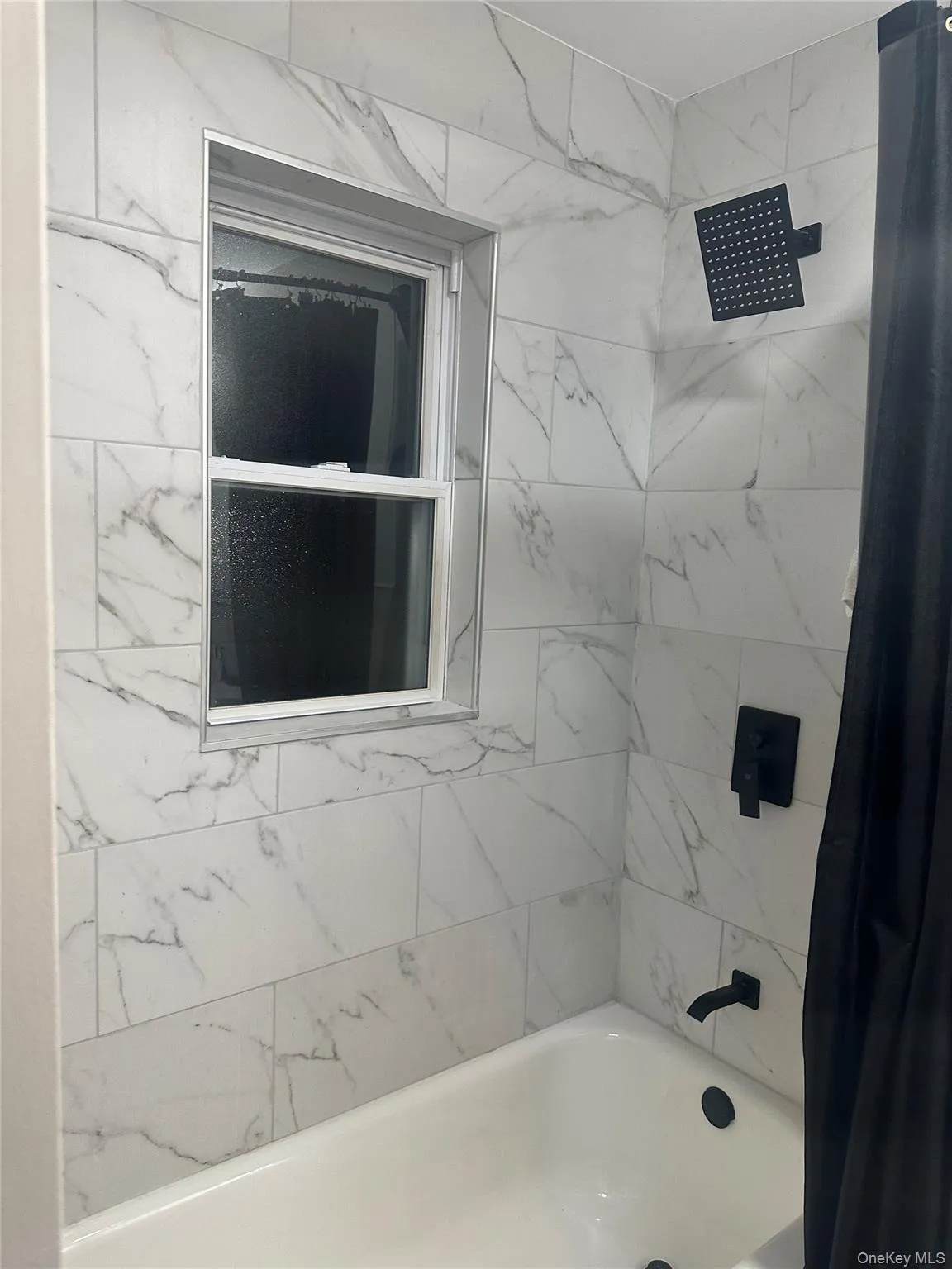 Full bathroom featuring shower / bath combo with shower curtain Full bathroom featuring shower / bath combo with shower curtain