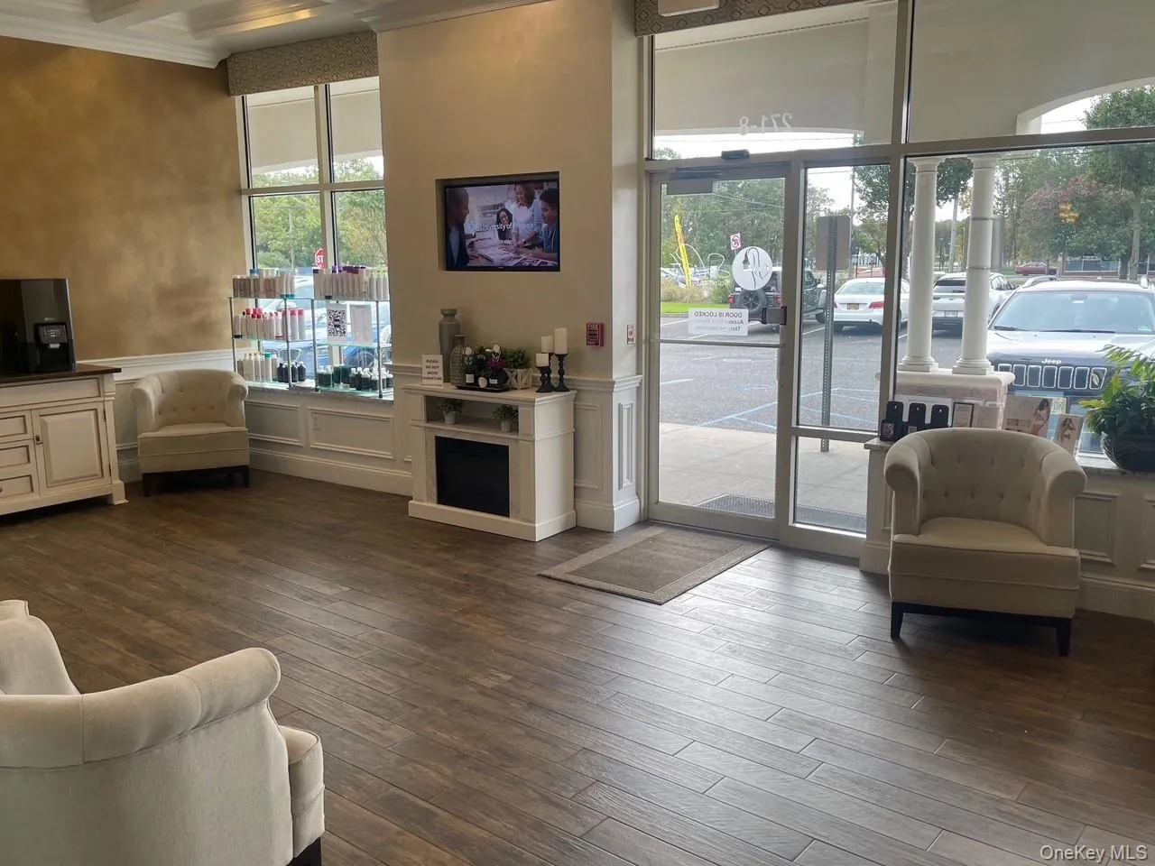 Community lobby featuring wainscoting, a decorative wall, and beam ceiling Community lobby featuring wainscoting, a decorative wall, and beam ceiling