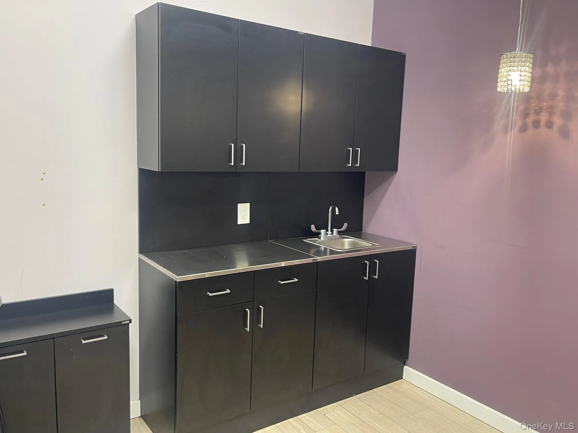 Bar with dark cabinets, dark countertops, modern cabinets, and pendant lighting Bar with dark cabinets, dark countertops, modern cabinets, and pendant lighting