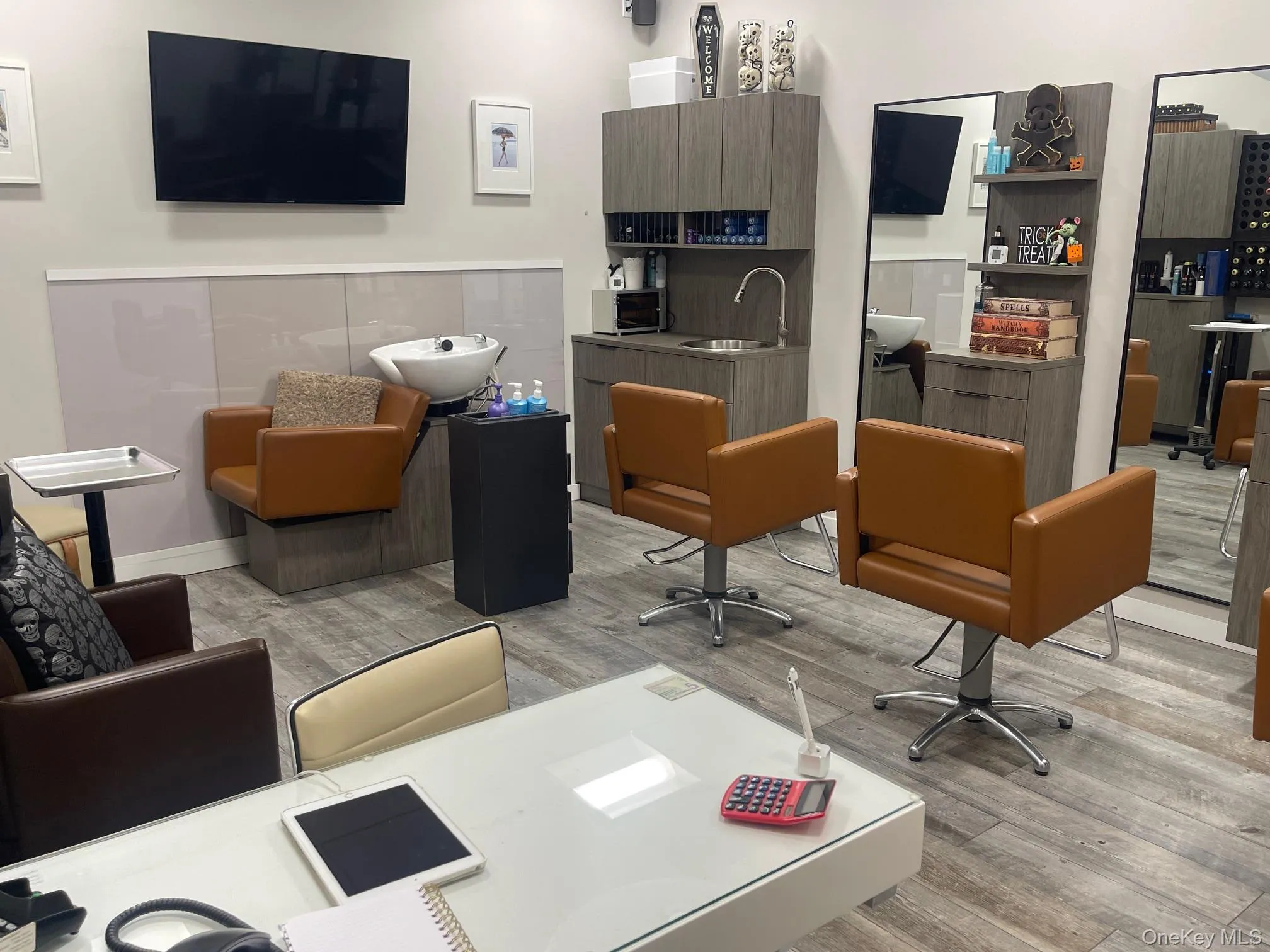 Home office with light wood-type flooring and a sink Home office with light wood-type flooring and a sink