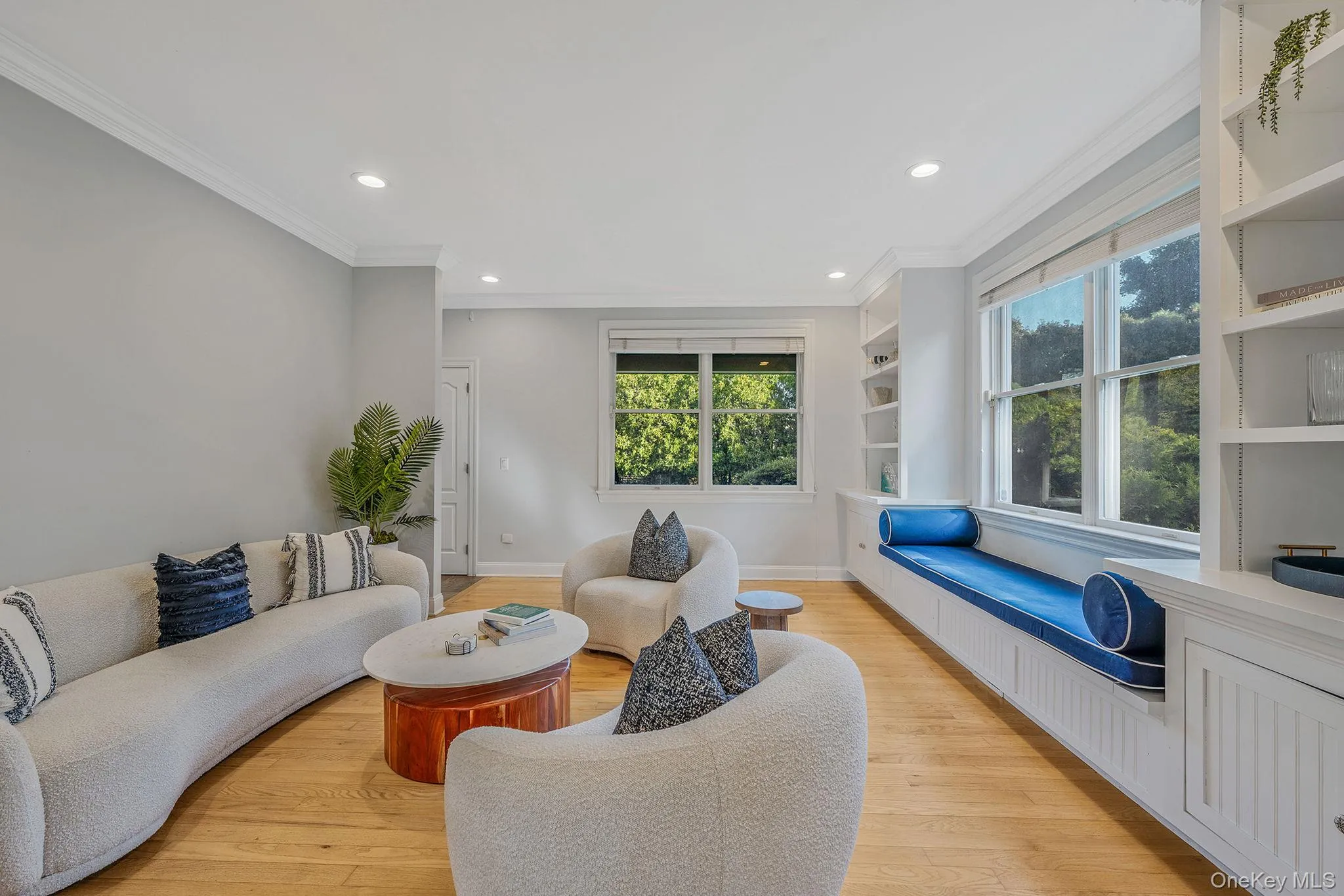 Living area featuring ornamental molding, light wood-style floors, and recessed lighting Living area featuring ornamental molding, light wood-style floors, and recessed lighting
